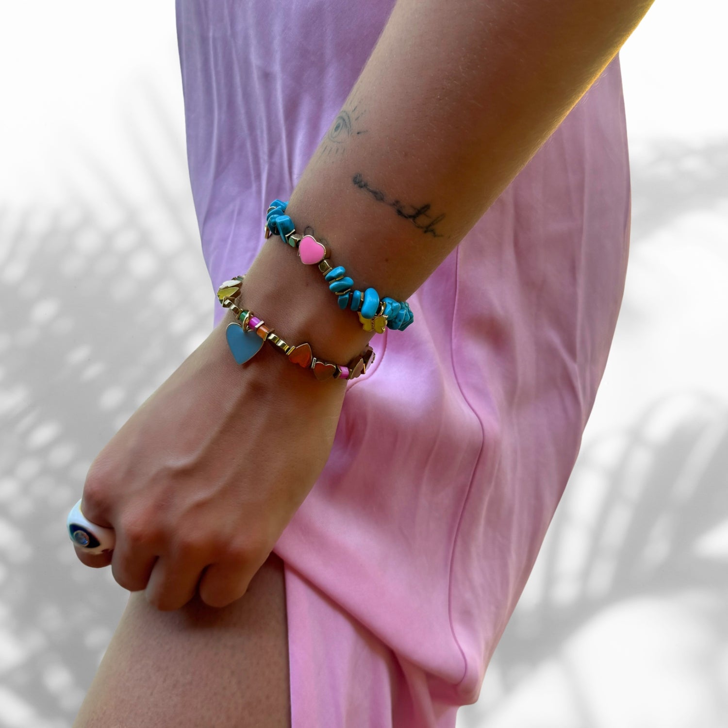 Model Wearing Handmade Bracelet with Gold Hematite and Blue Heart Charm