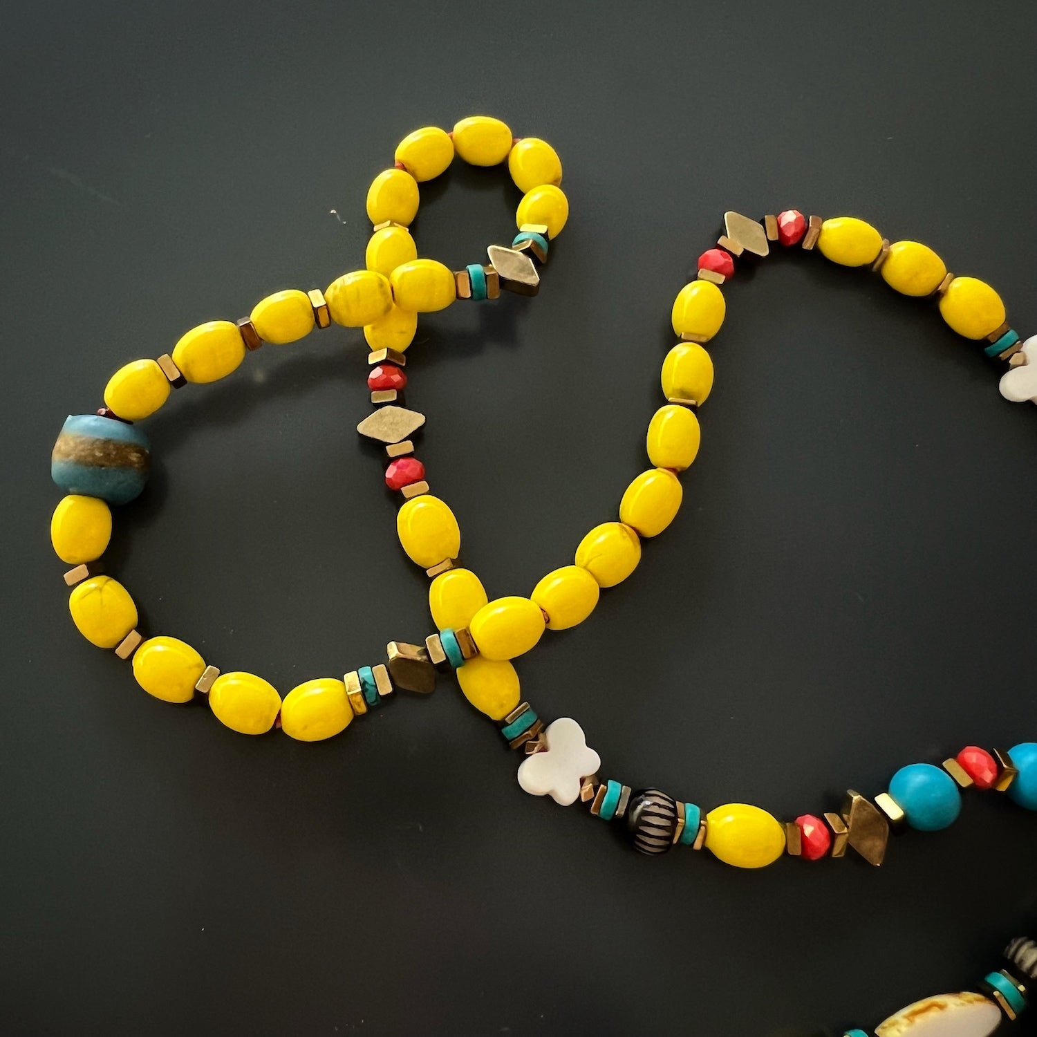 Carpe Diem Necklace featuring a vibrant combination of turquoise stone beads and African handmade beads, exuding style and positivity.