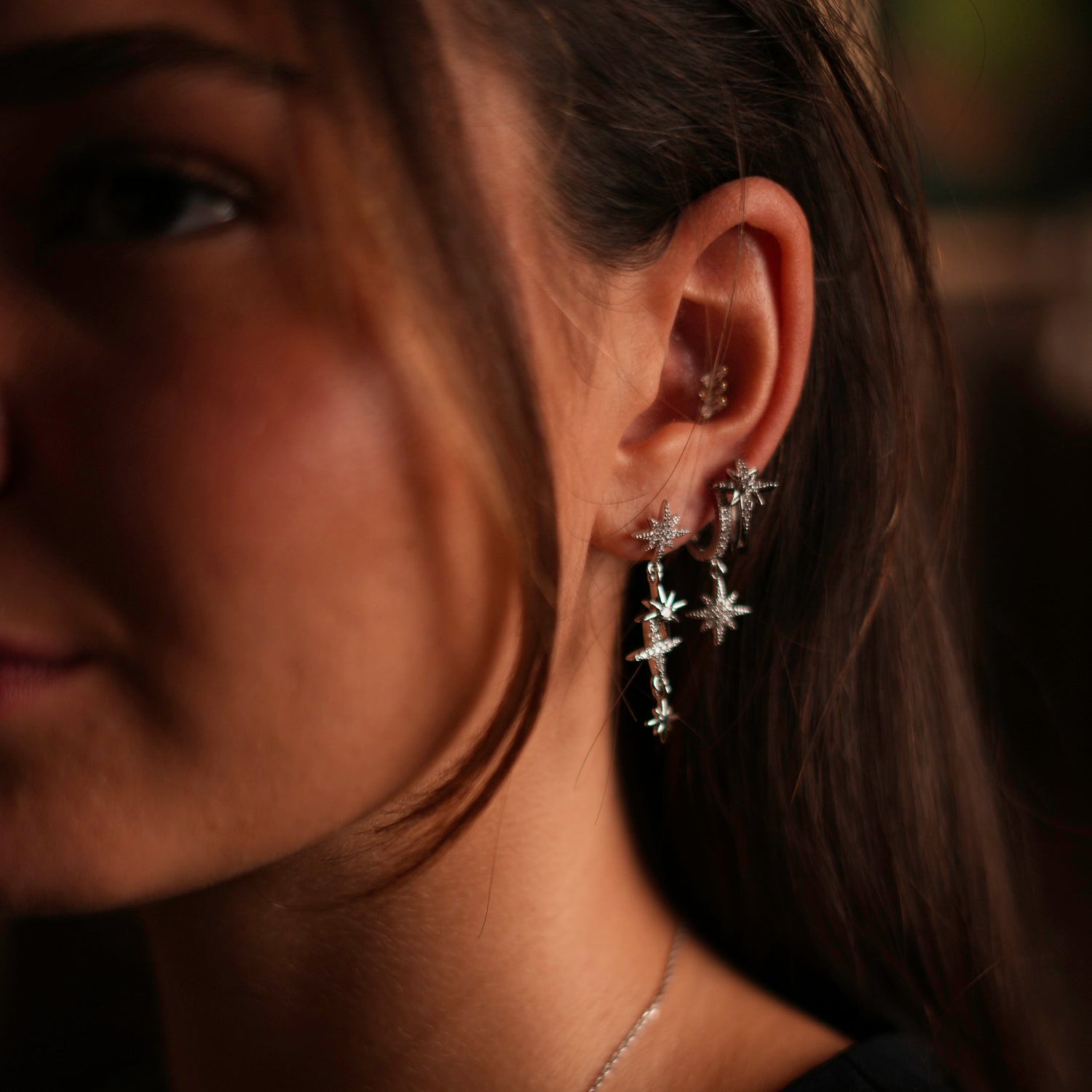 Versatile silver earring set with three star charms and diamond accents, ideal for a celestial statement