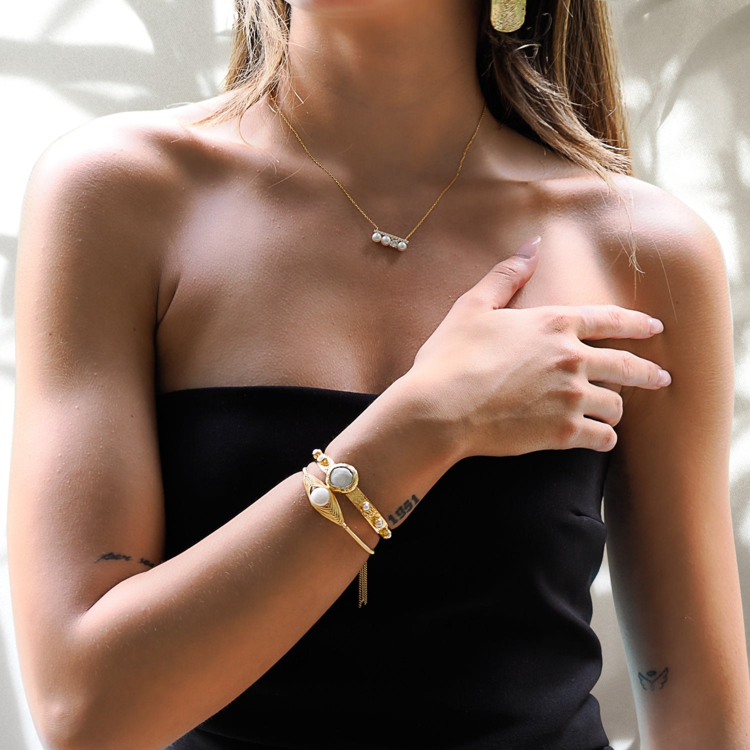 Model wearing: Cleopatra Gold &amp; Pearl Cuff Bracelet radiates regal grace.
