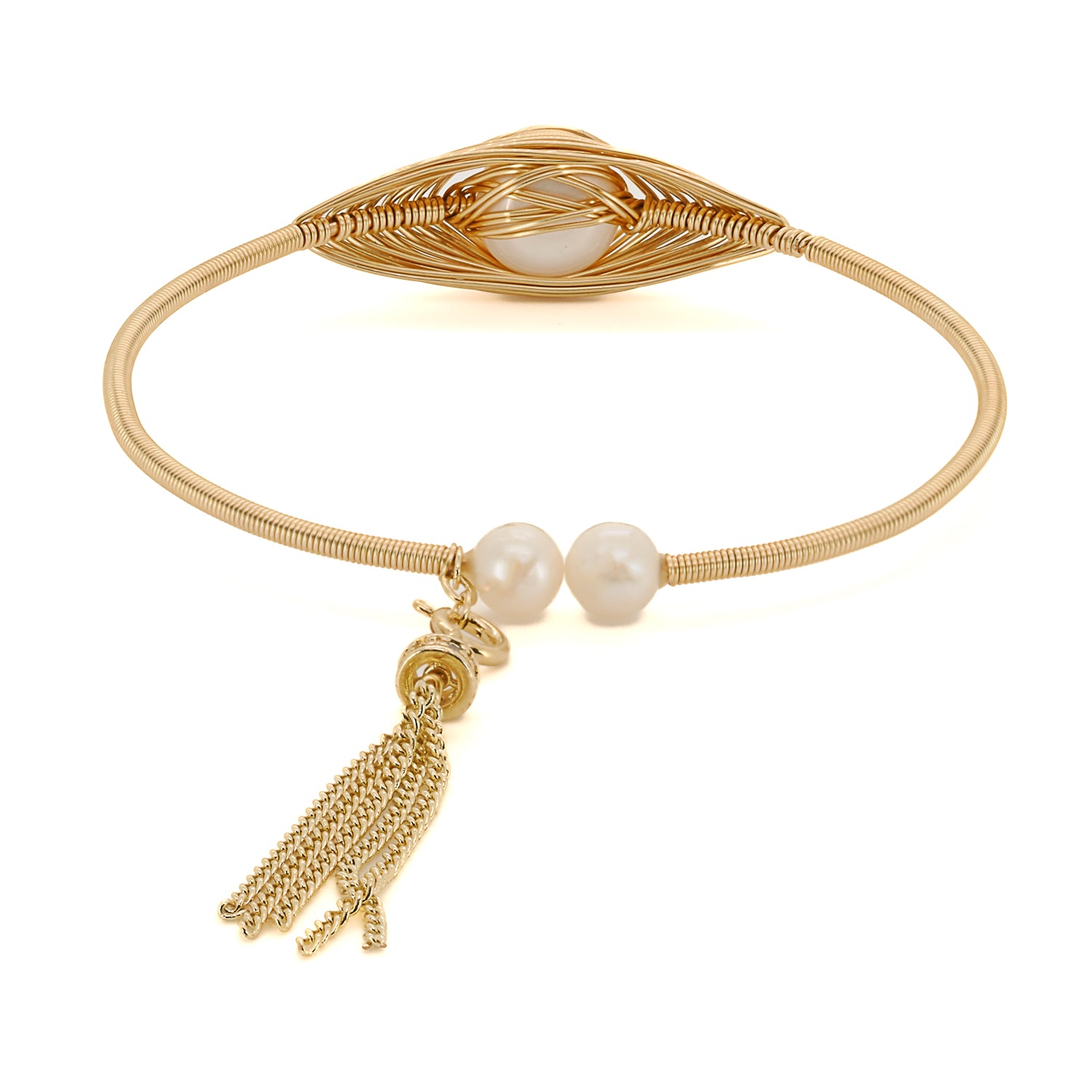 Captivating centerpiece: gold and pearl bangle bracelet exudes opulence.