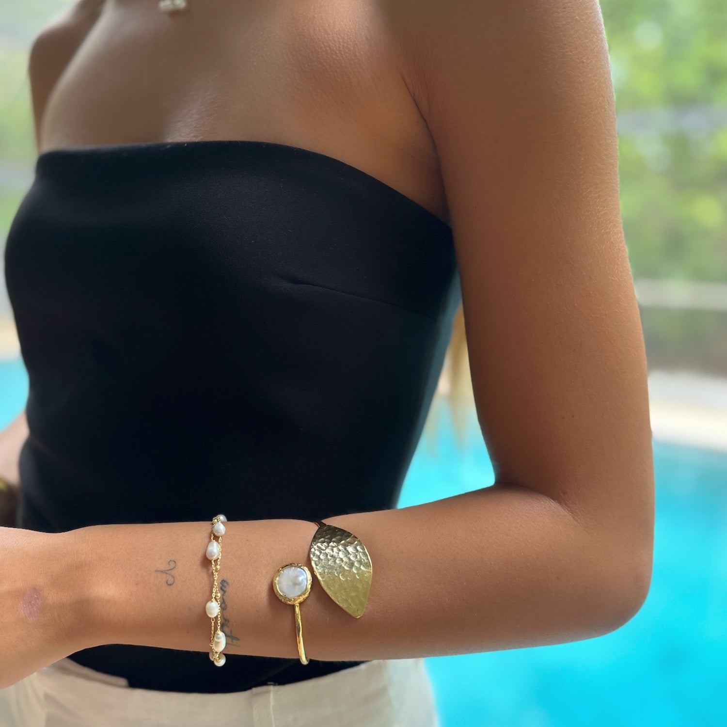 Model embraces uniqueness with the radiant Cleopatra Pearl Leaf Cuff.