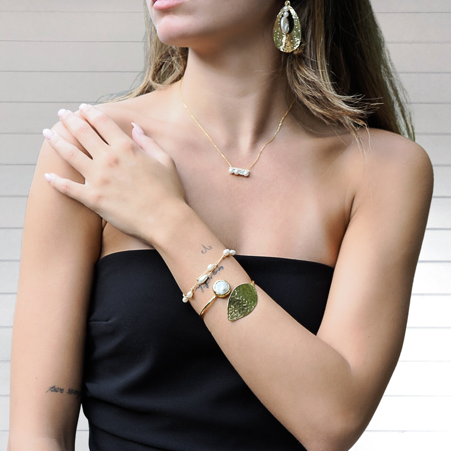 Model shines in luminous luxury with the Gold Leaf Cuff Bracelet.
