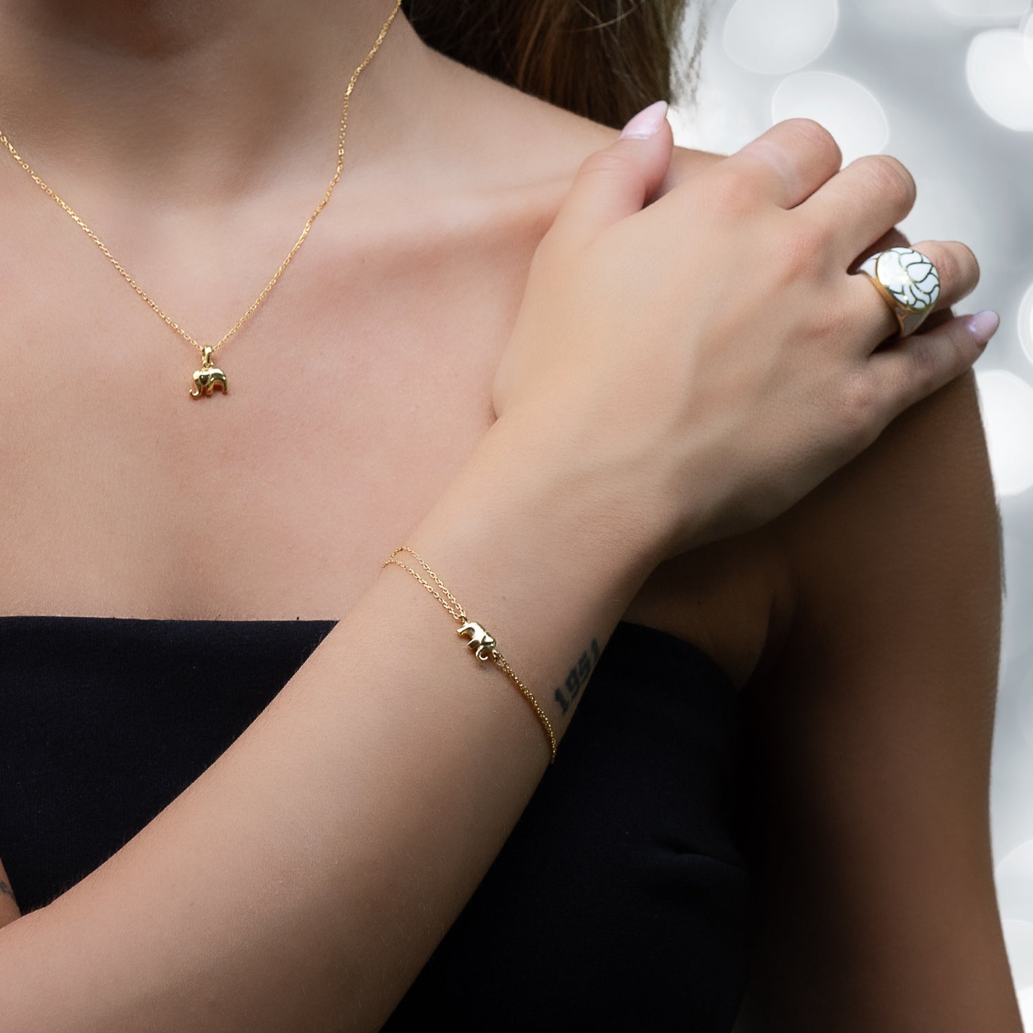 Model embraces strength and luck with Elephant charm bracelet.