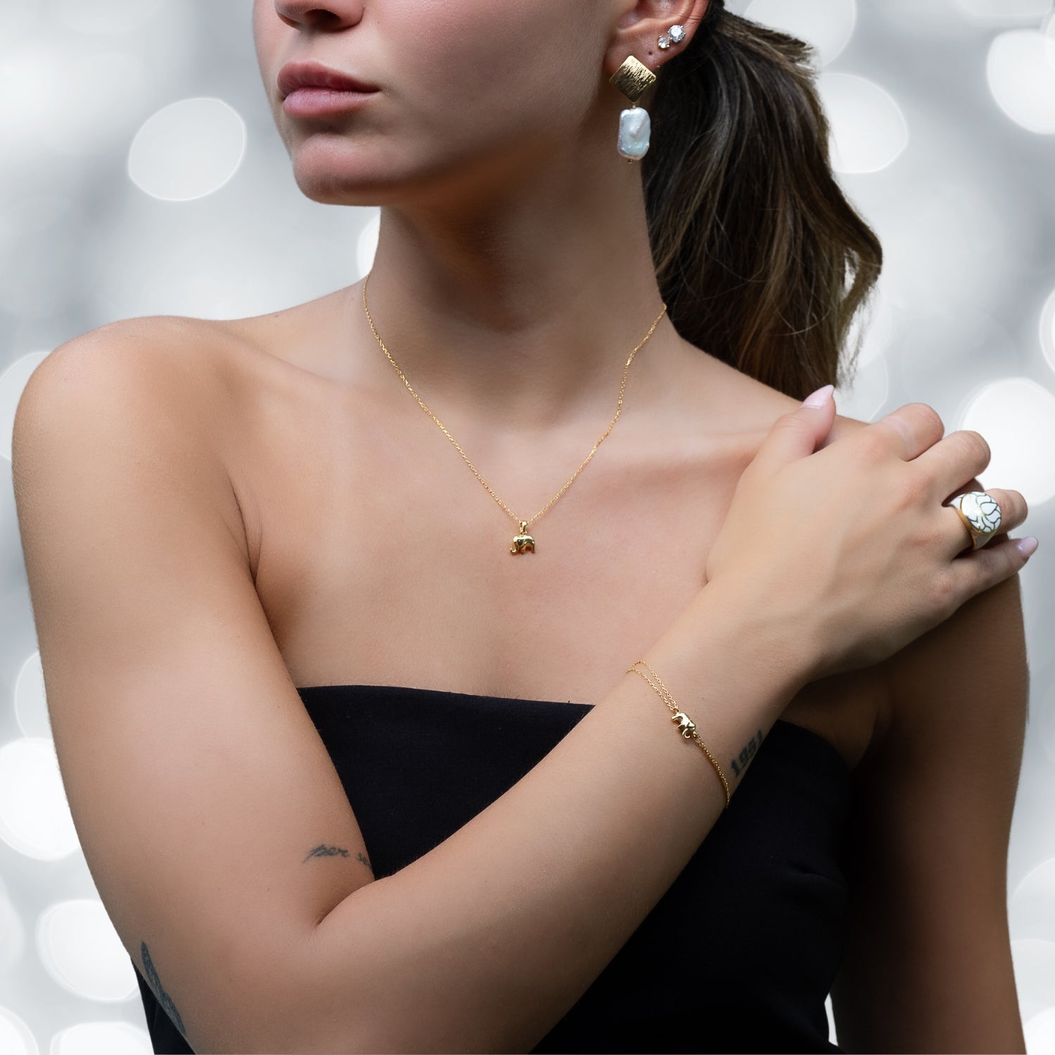 Model showcases the elegance of Dainty Gold Elephant Bracelet.