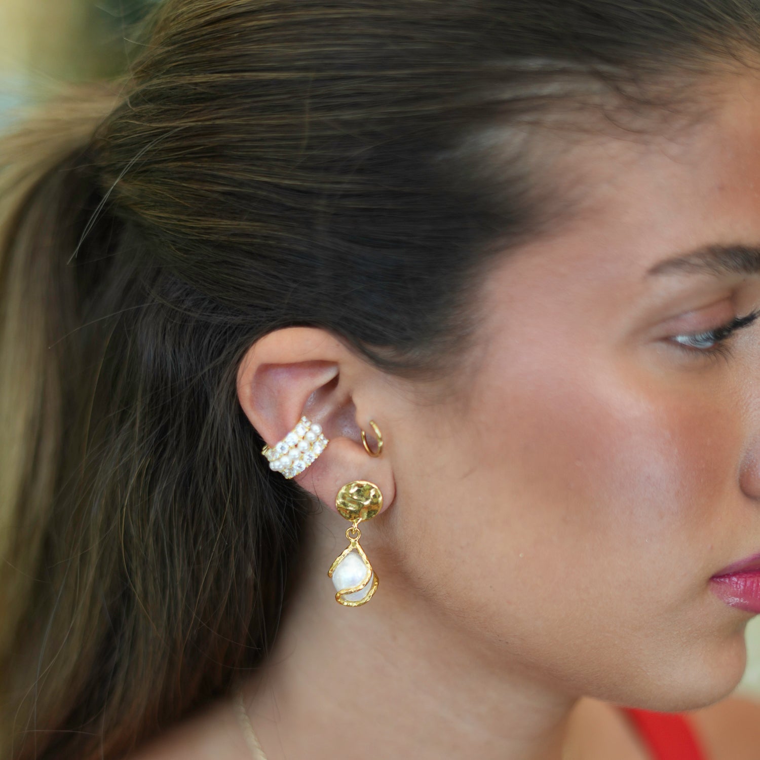 Stylish gold cuff earring combining the timeless beauty of pearls with the brilliance of CZ diamonds