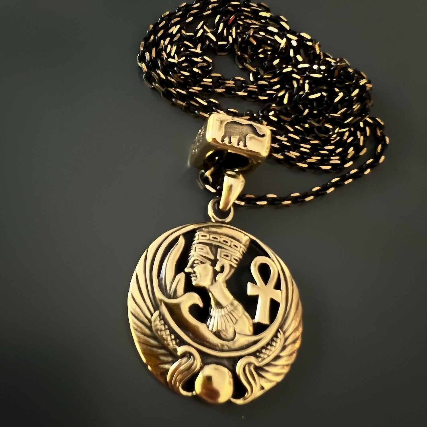 Intricately Designed Nefertiti Necklace with Symbolic Bead, symbolizing wisdom, good luck, and protection.