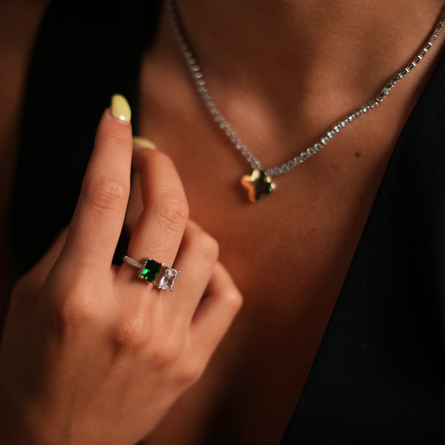 Sterling silver ring with a striking emerald and diamond design, embellished with CZ diamonds