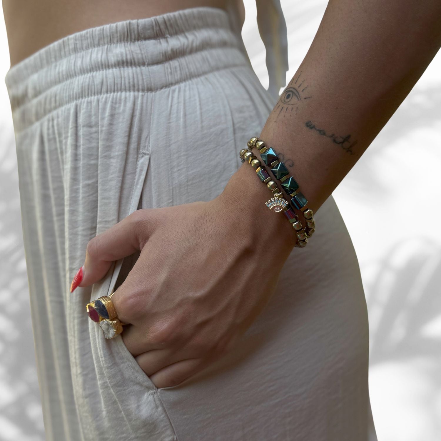 Model Wearing Handmade Bracelet Set with Colorful Hematite Beads and Evil Eye Charm