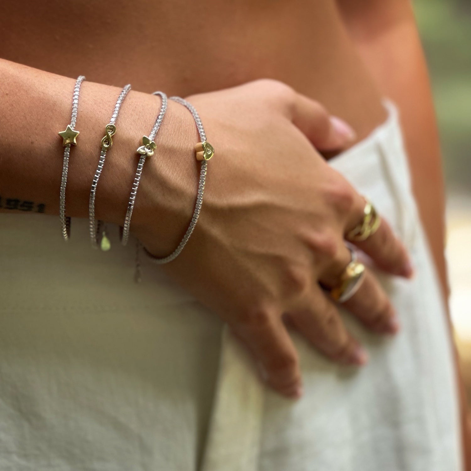 Model radiates elegance with Gold Butterfly Diamond Bracelet.