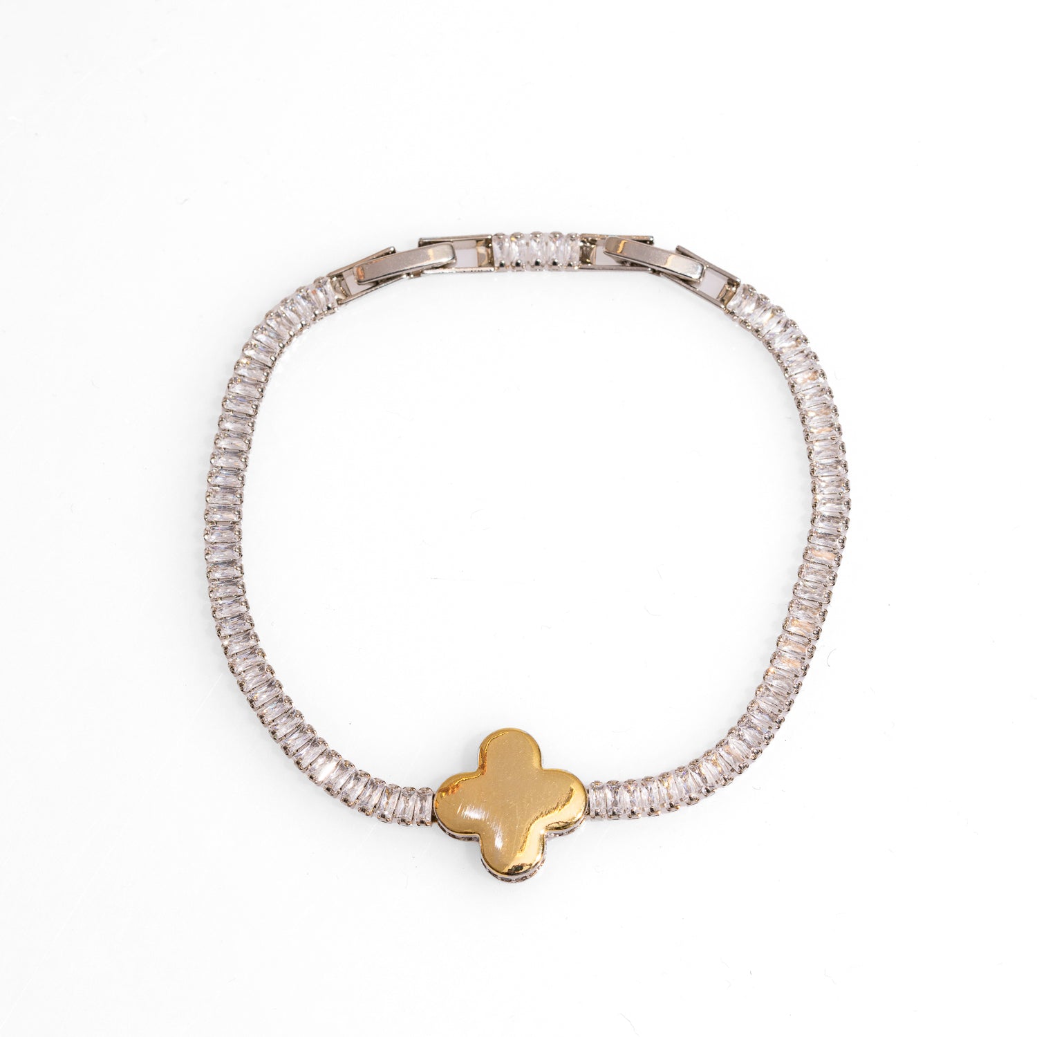 Baguette diamond bracelet with a gold clover charm, symbolizing luck and prosperity