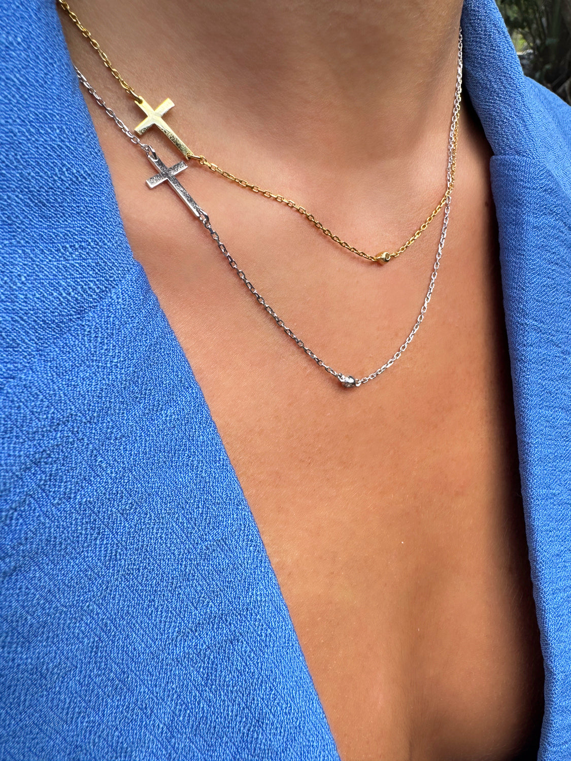 Gold cross pendant on a diamond chain necklace, symbolizing protection and faith