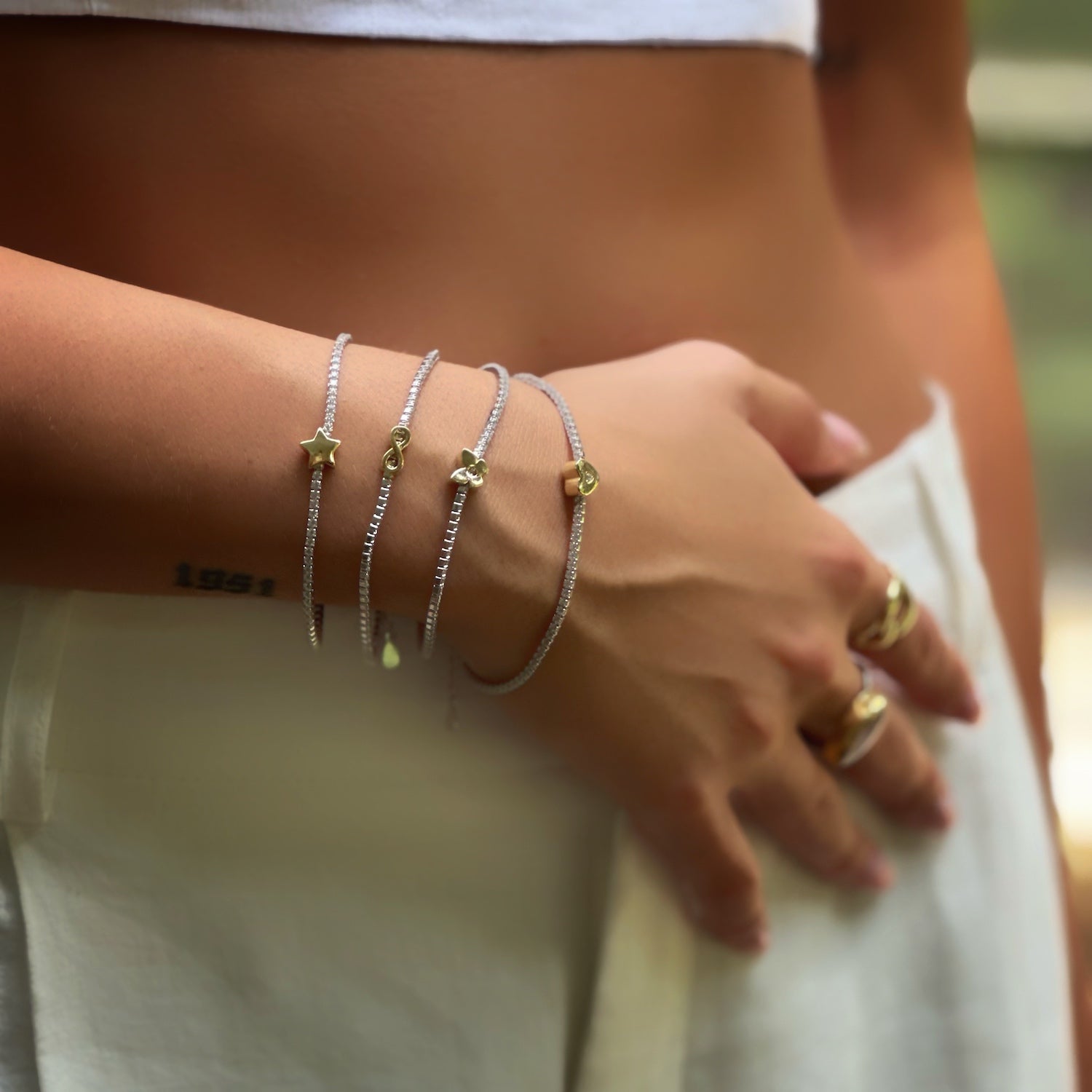 Love and allure: Model enhances her style with Gold Heart Bracelet.
