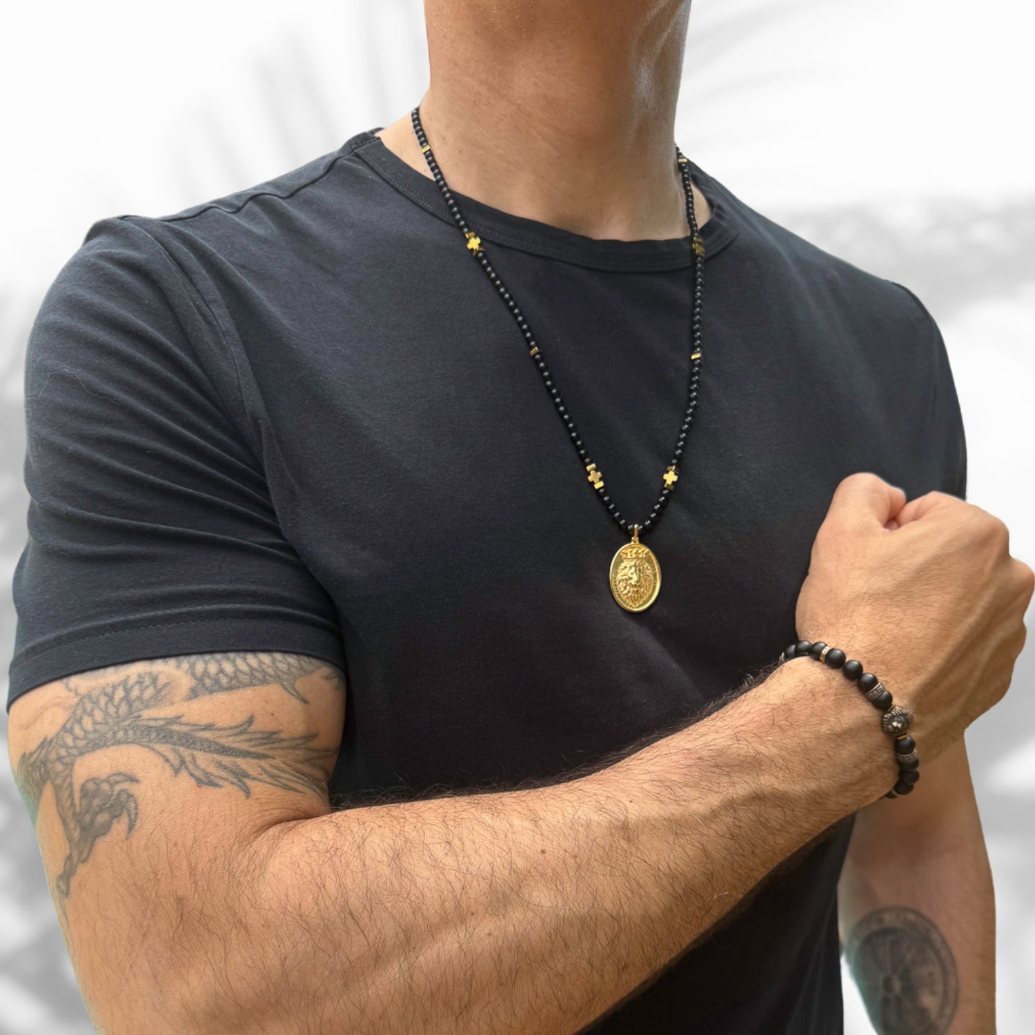 Men's necklace featuring black onyx stones and a gold-plated lion pendant, symbolizing courage and strength