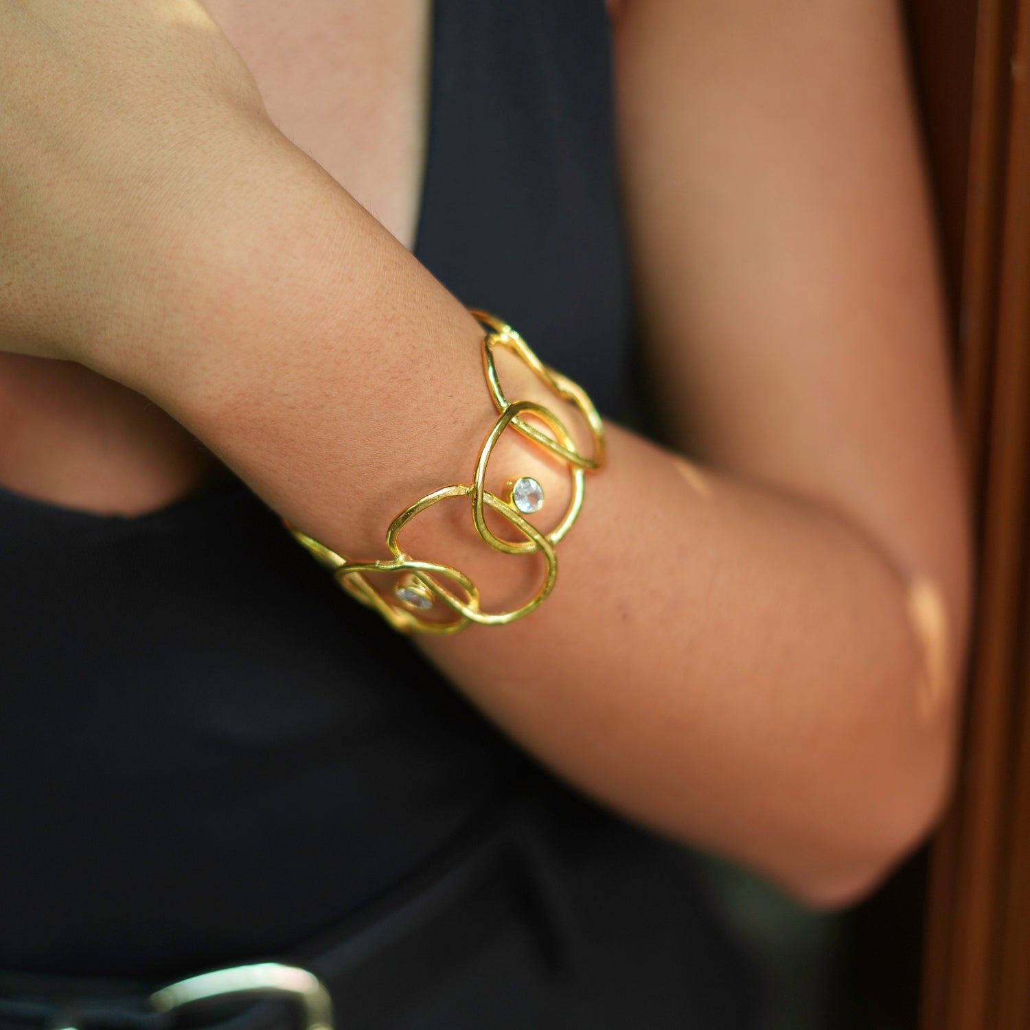 Chunky gold cuff bracelet featuring two sparkling CZ diamonds, crafted from high-quality brass and plated with 24k gold.