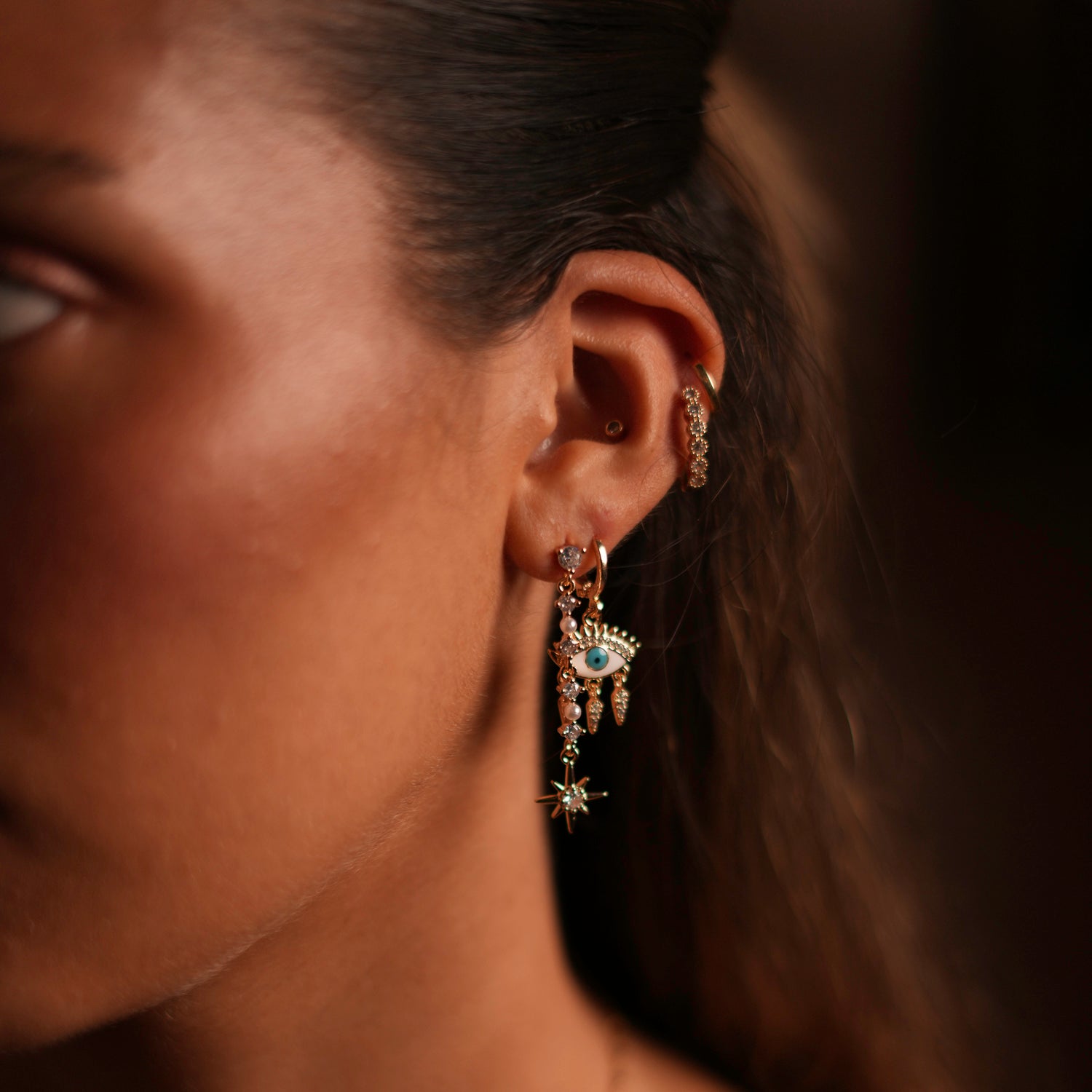 Gold-plated trio earrings with white and blue enamel, featuring Evil Eye and Guidance Star charms with CZ diamonds.