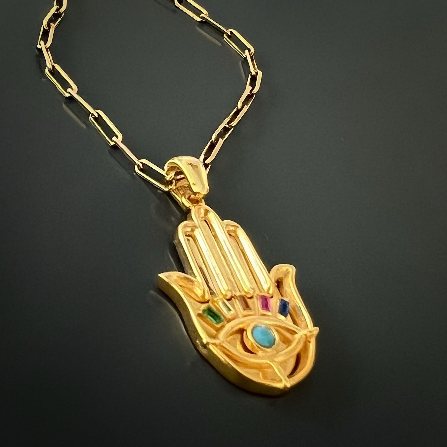 Turquoise Hamsa Necklace - This beautiful necklace showcases a gold-plated Hamsa pendant with a calming turquoise stone, symbolizing protection and positive energy.