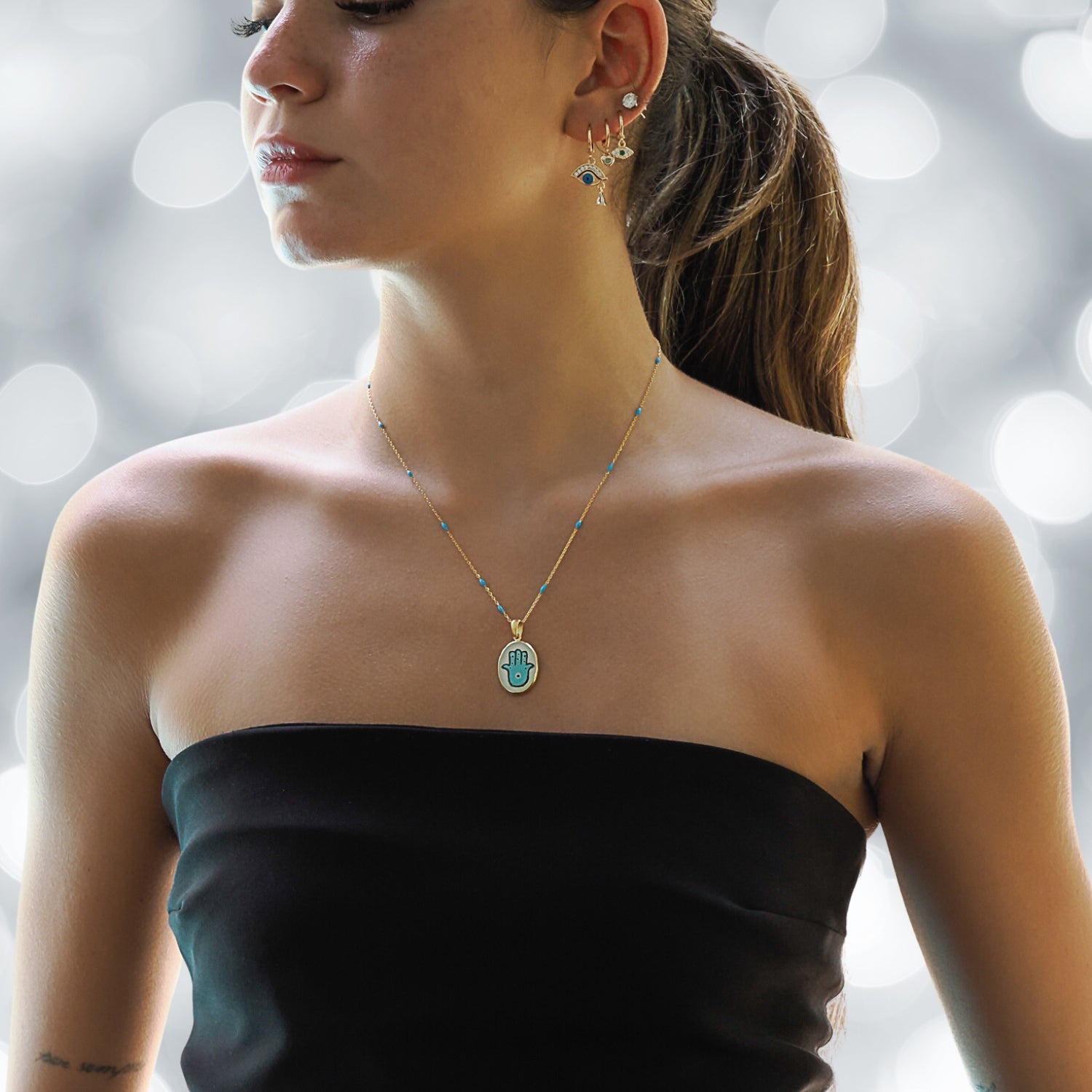 Model Wearing a Hamsa Good Fortune Turquoise & Gold Chain Necklace - Embodying Protection and Style.