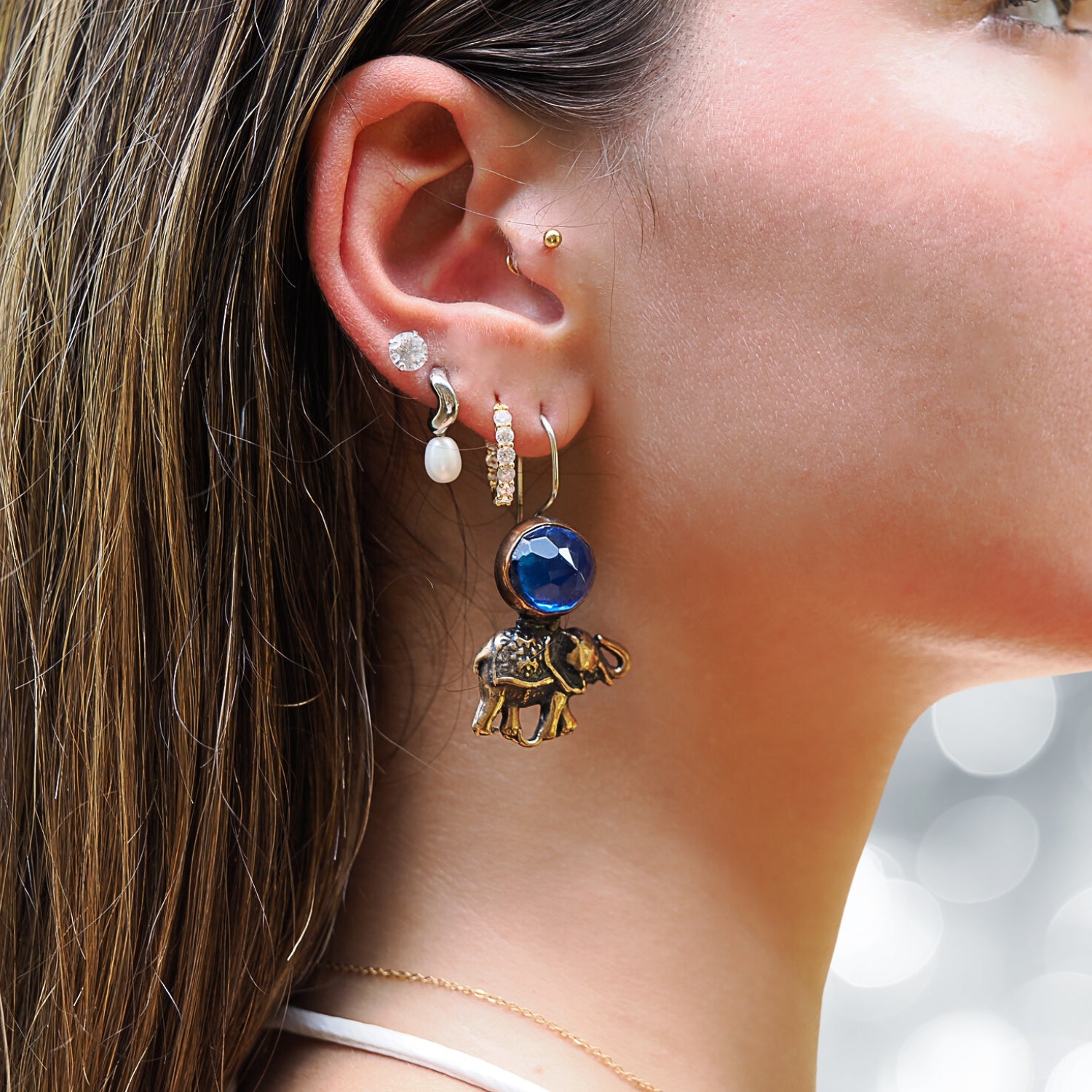 Elephant Earrings featuring handmade bronze charms and sapphire gemstones, a unique addition to your jewelry collection.