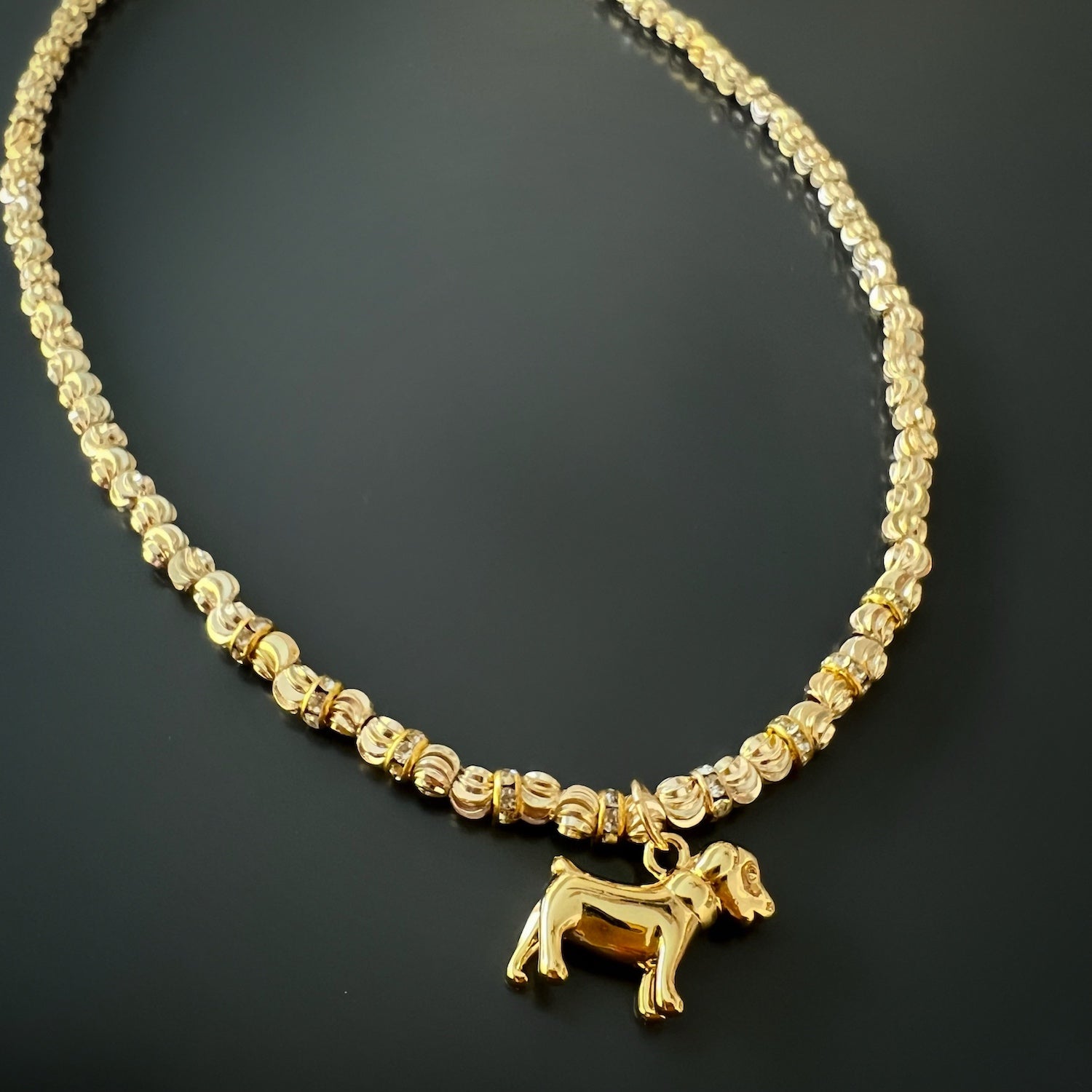 the Happy Dog Gold Necklace, capturing the lovely arrangement of the dog pendant, chain, and extender. The 18K gold plated charm gleams under the light, creating a delightful and whimsical accessory.