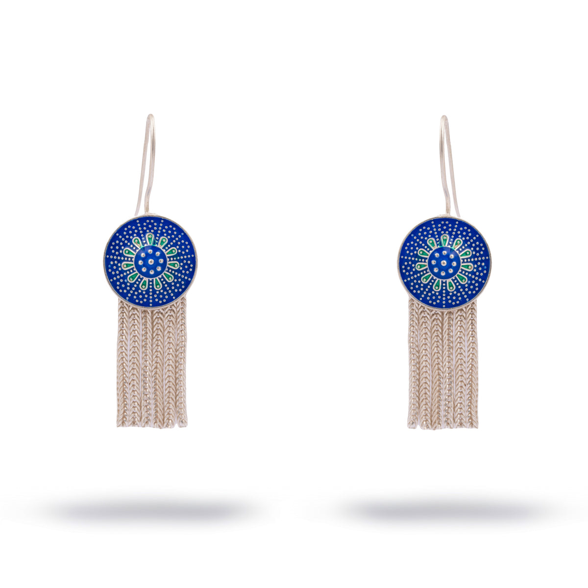Silver drop earrings with a cobalt blue enamel bloom medallion above a woven silver chain tassel
