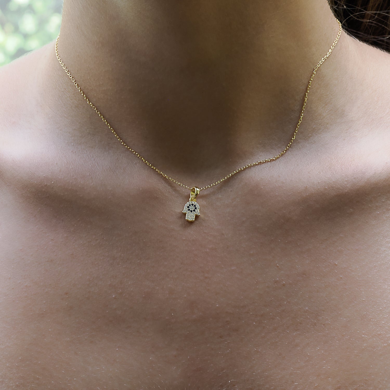 Mini Hamsa Hand Necklace Worn by a Stylish Model - A Symbolic Statement.