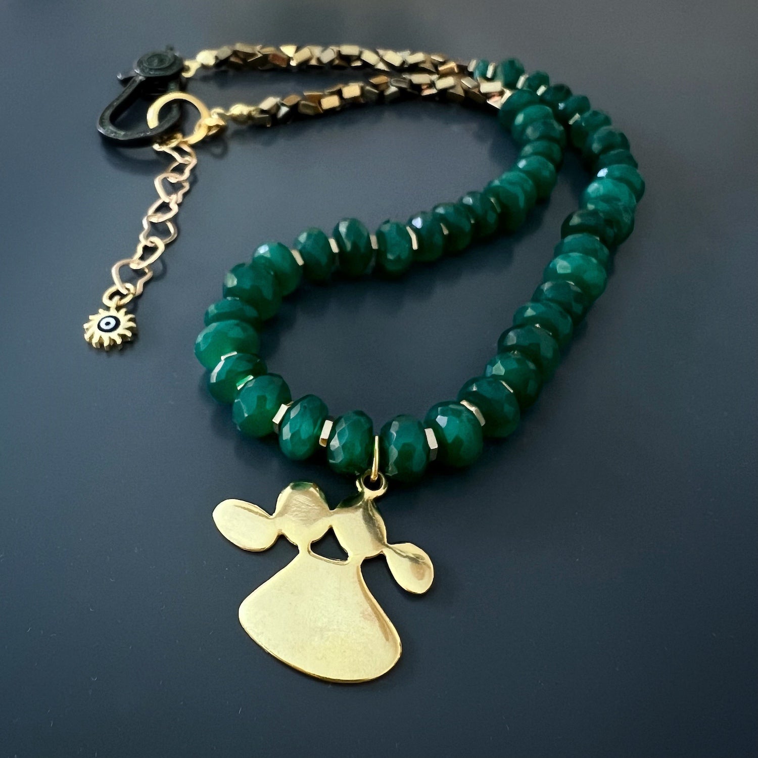 The Mother and Daughter Jade Necklace, as seen in the image, radiates love and devotion, with its stunning jade beads and the beautiful mother and daughter pendant.