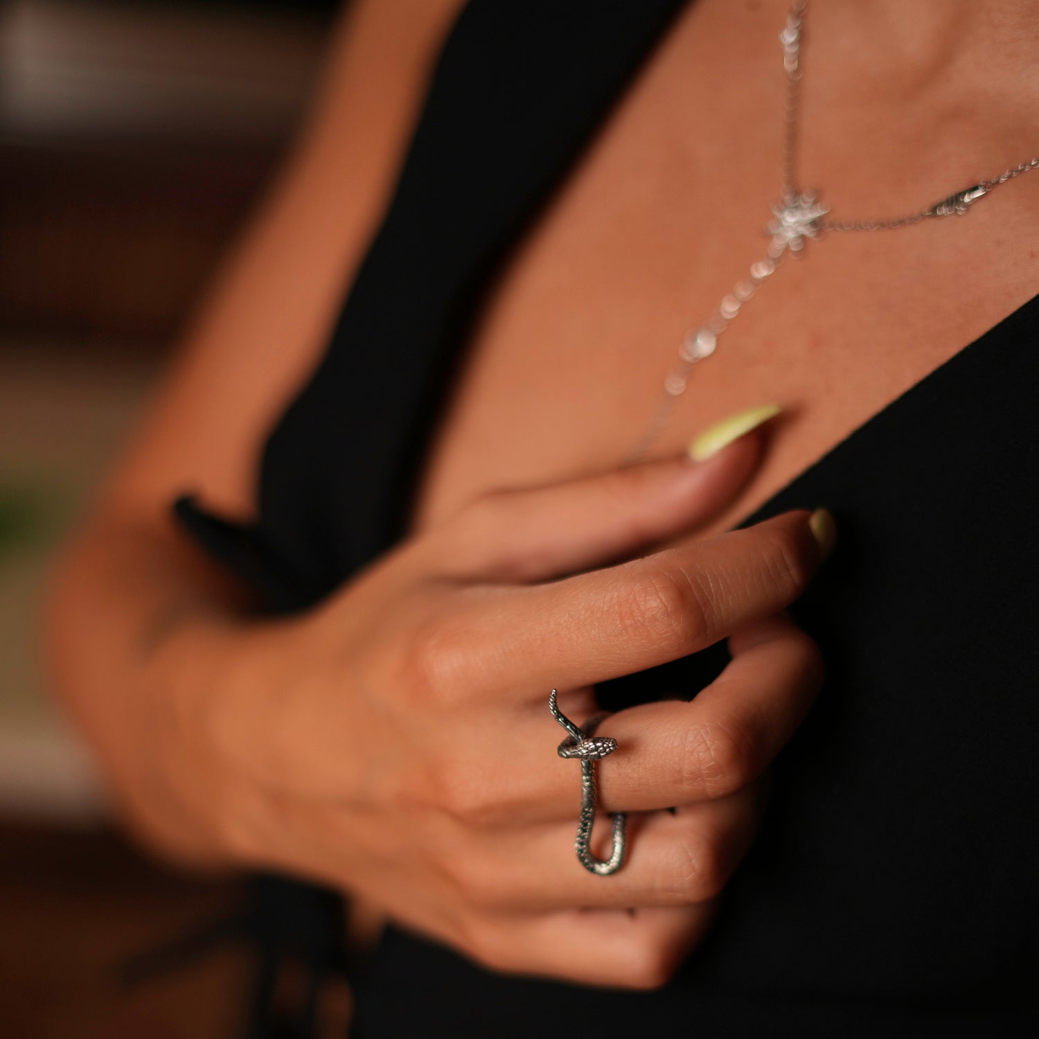 Elegant sterling silver ring with a detailed snake motif and sparkling black Cz diamonds, representing timeless beauty and mystique.
