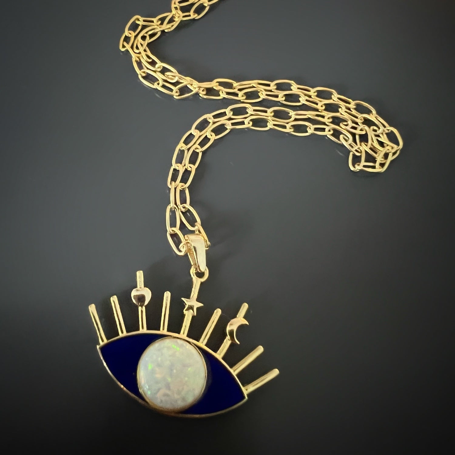 A detailed shot of the captivating Evil Eye pendant on the Opal Blue Evil Eye Necklace.