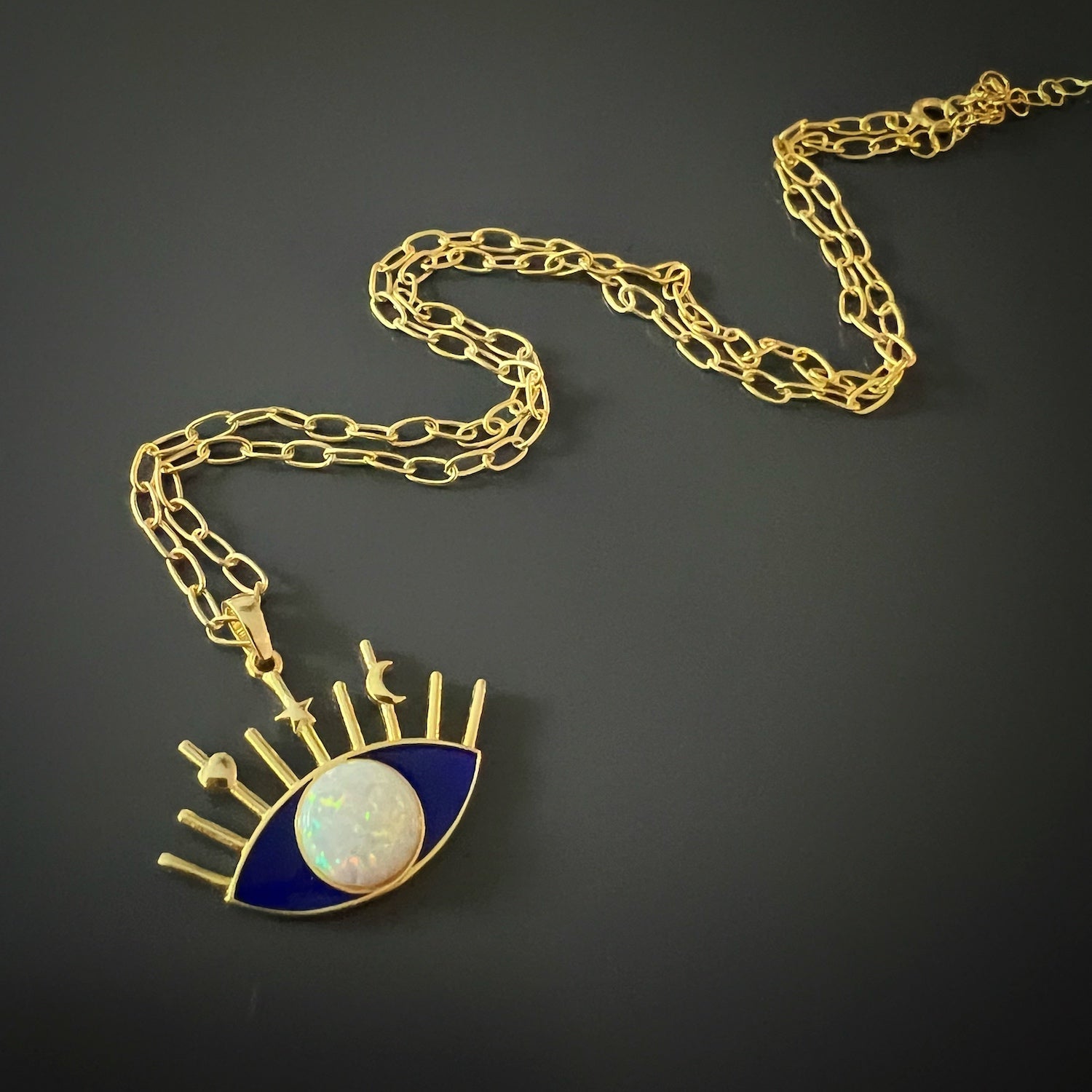 The Opal Blue Evil Eye Necklace, a unique accessory that embodies spirituality and beauty.