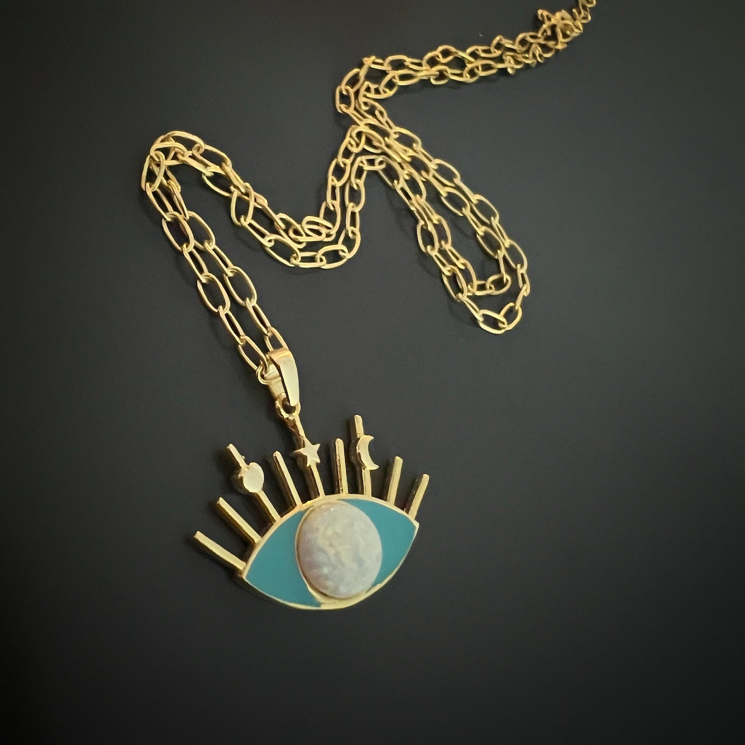 A detailed shot of the enchanting Evil Eye pendant on the Opal Turquoise Evil Eye Necklace.