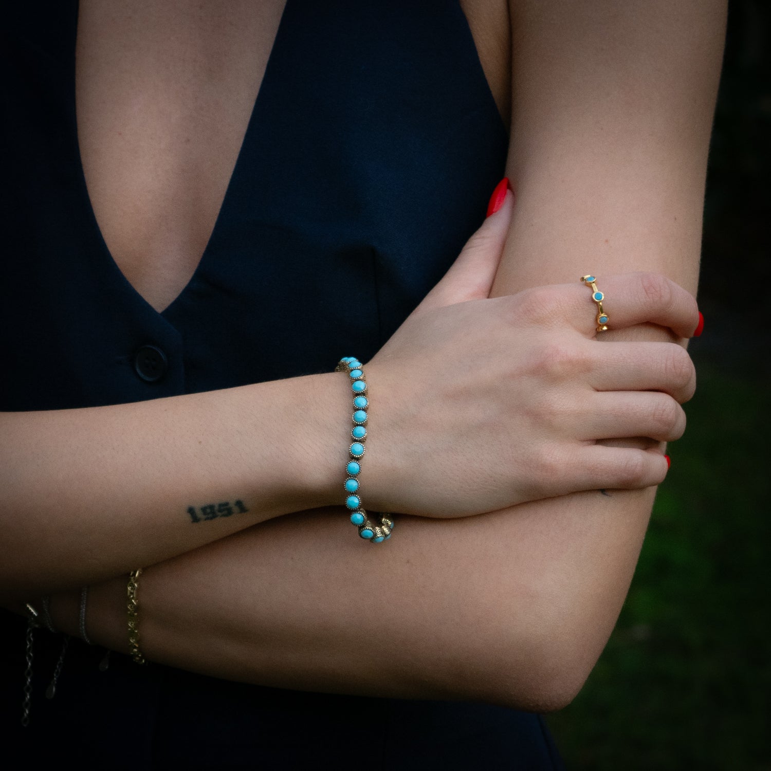 Handmade 24K gold-plated brass ring featuring evenly spaced turquoise stones

