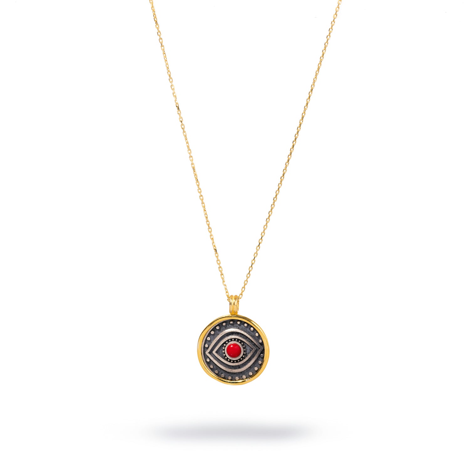 Sterling silver necklace featuring a red coral evil eye pendant with a gold-plated border, designed to offer protection and vibrant energy.