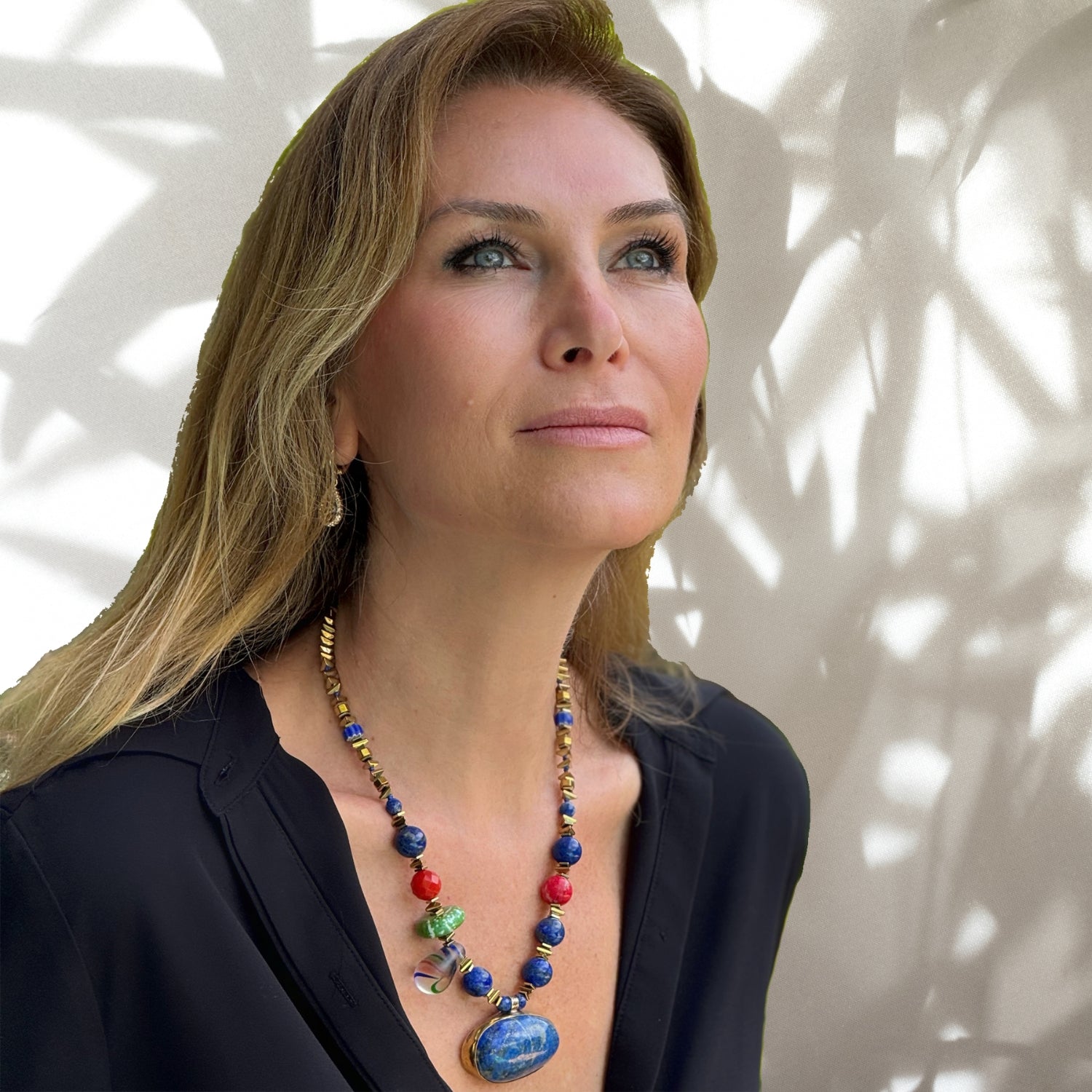 Handcrafted necklace with a striking lapis lazuli pendant, complemented by gold hematite spacers and vibrant beads of turquoise, coral, and varacite