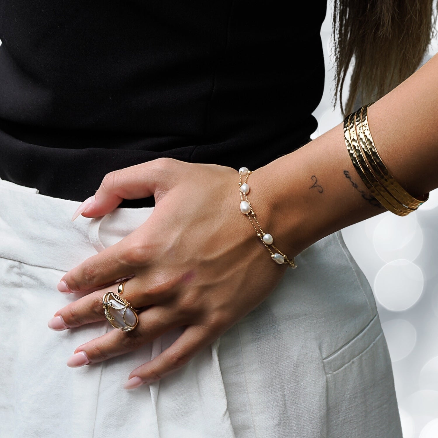 Model exudes elegance with Pearl Gold Chain Bracelet.