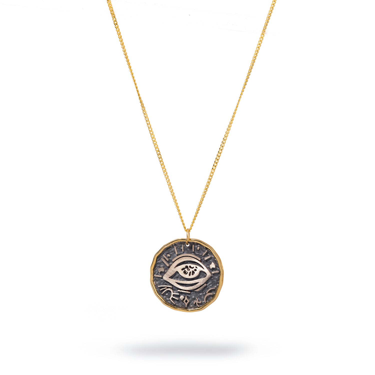 Handcrafted protective eye symbol pendant in sterling silver, framed with 18k gold and suspended on a gold chain.