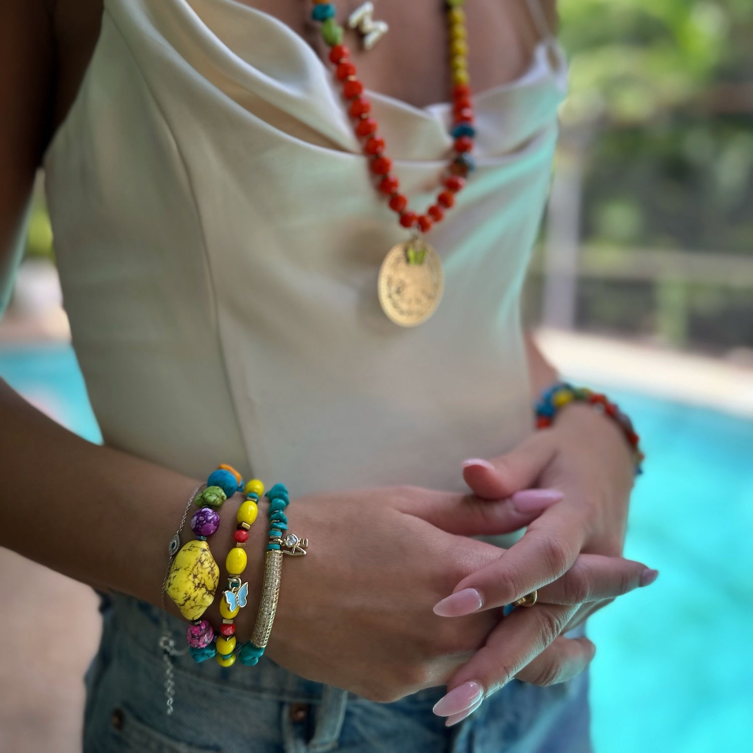 See how the Rainbow Butterfly Bracelet beautifully adorns the hand model's wrist, exuding a sense of whimsy and elegance.