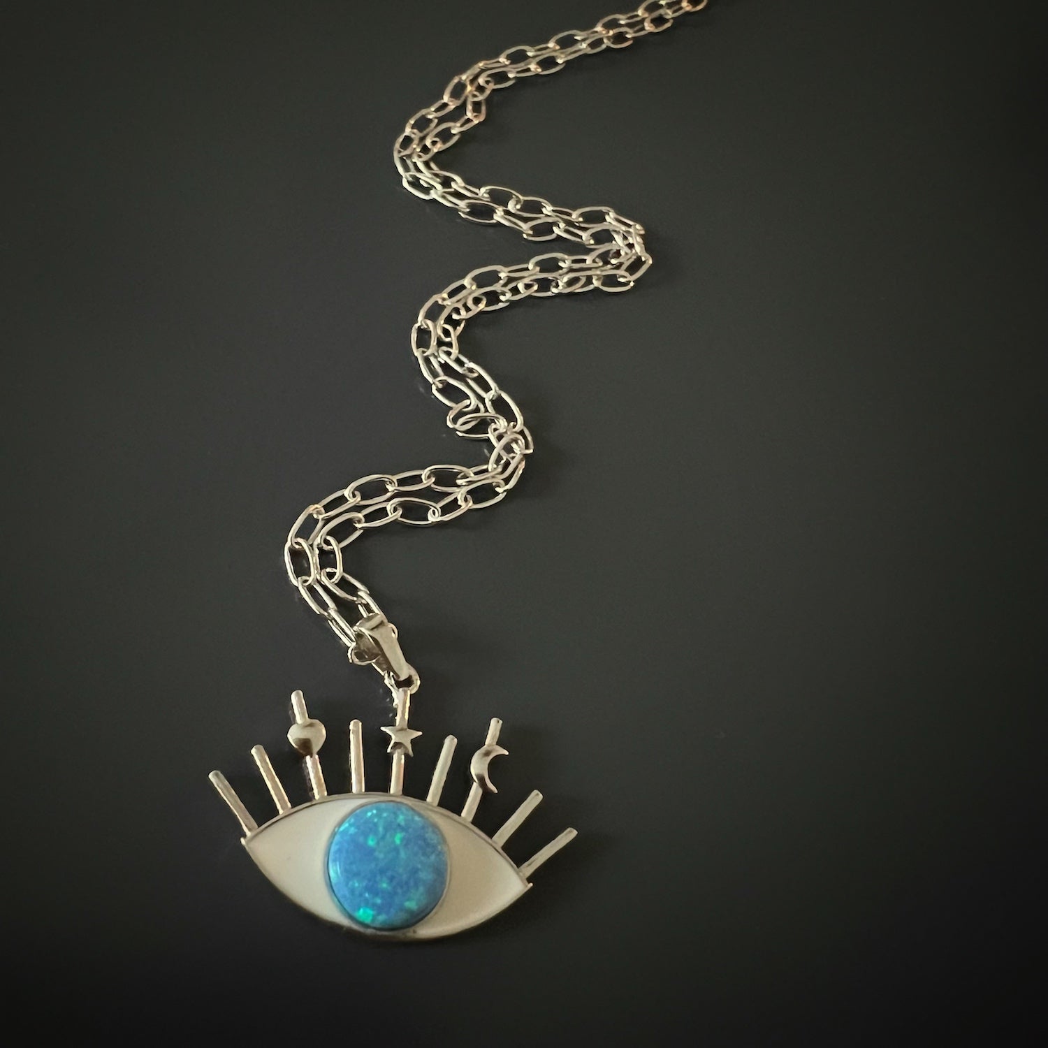 A detailed shot of the captivating Evil Eye pendant on the Silver Blue Opal Evil Eye Necklace.