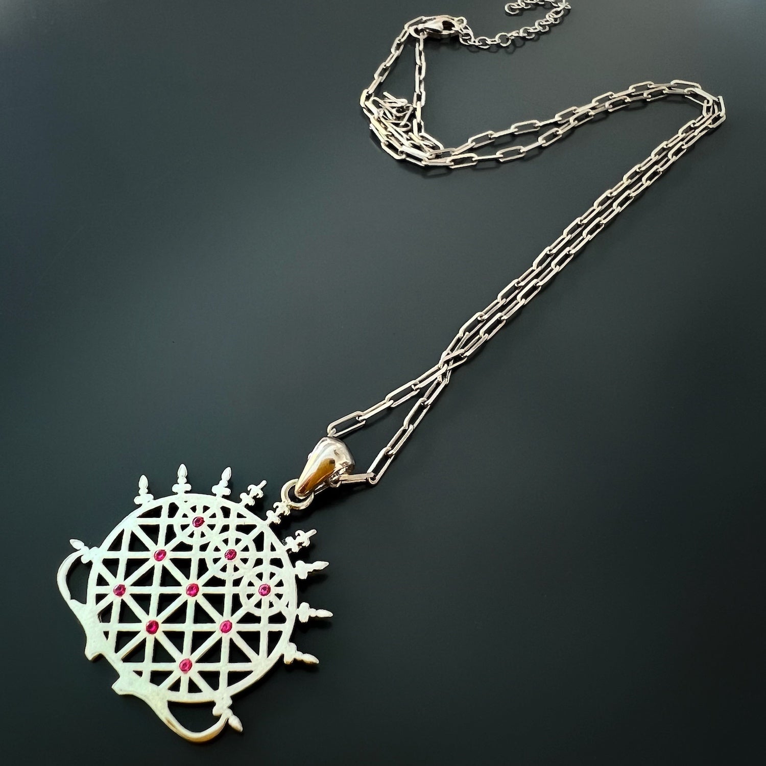 the Silver Hittite Sun Disc Necklace, showing the pendant resting close to the heart, symbolizing the importance of self-connection and inner warmth.