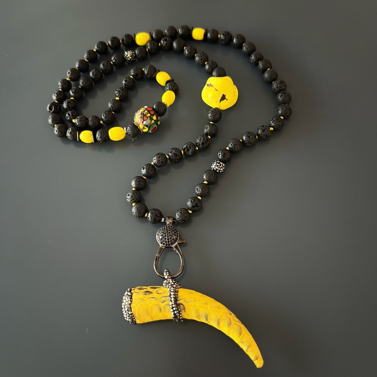 Combination of lava rock stones, zircon beads, and Nepal yellow beads, creating a harmonious and meaningful design in the Spirit Cornicello Unique Necklace.