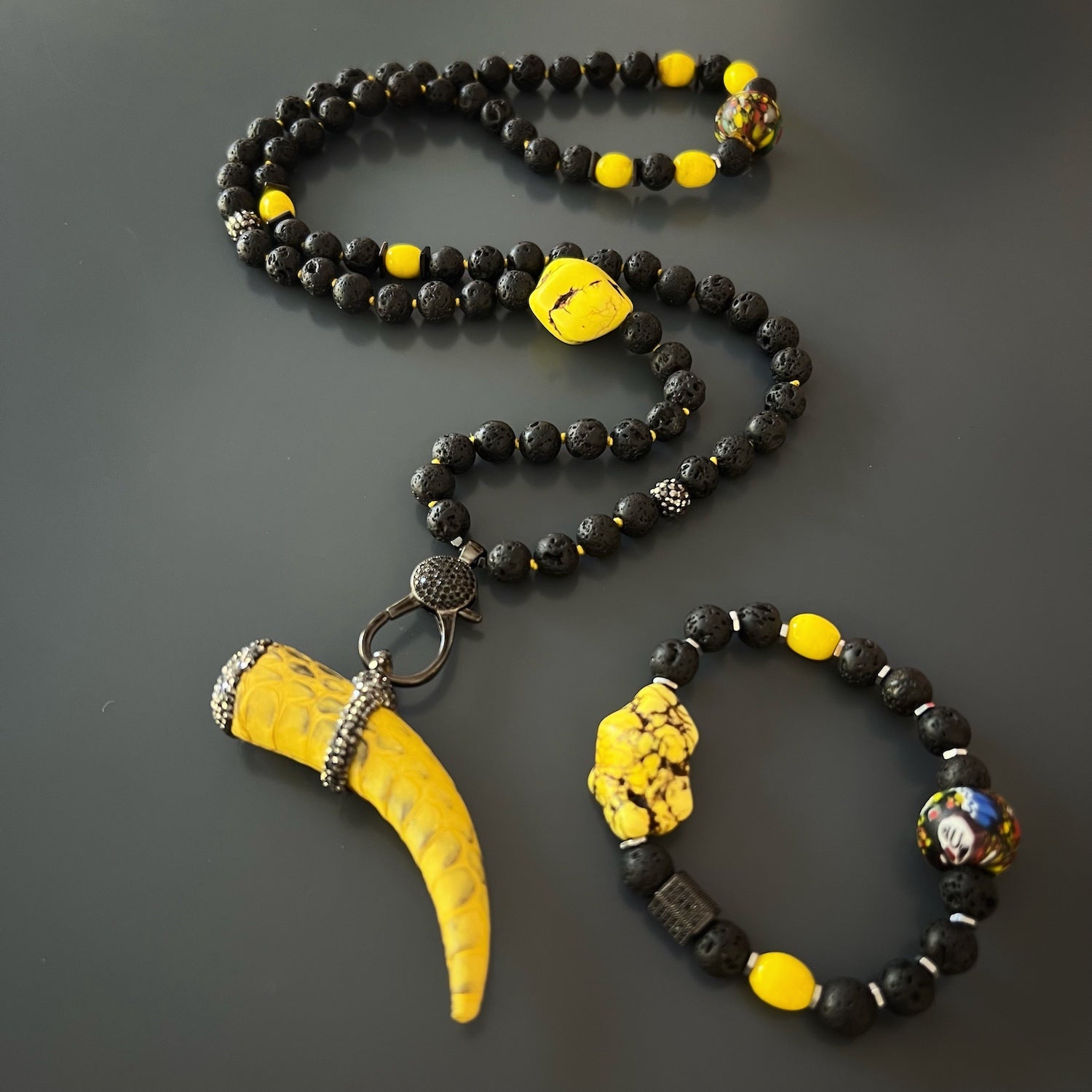 Vibrant yellow and zircon Cornicello pendant, a symbol of protection and good luck, catching the light in the Spirit Cornicello Unique Necklace.