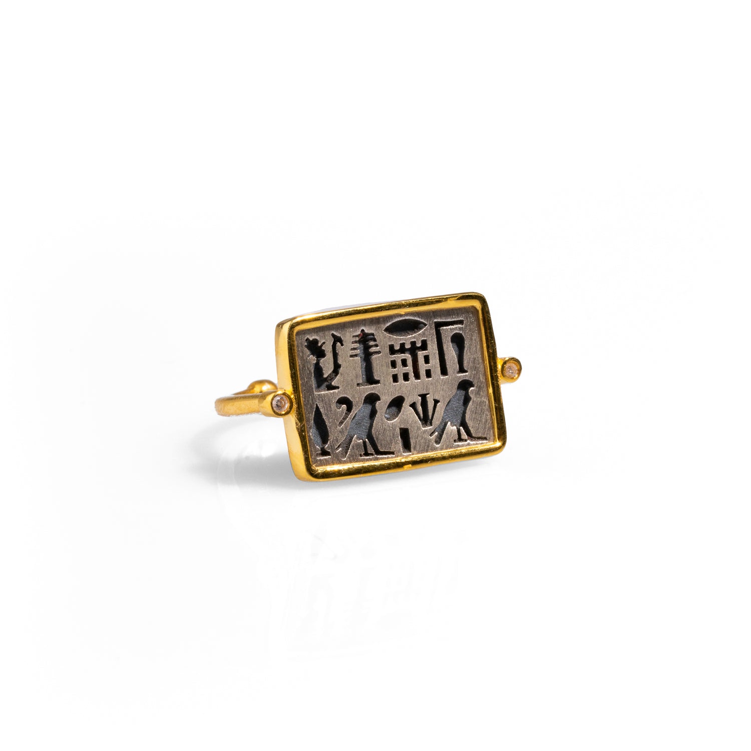 Stylish ring with a rectangular sterling silver face adorned with Egyptian symbols, encased in a luxurious 18k gold frame, adjustable from size 5.5 to 9.