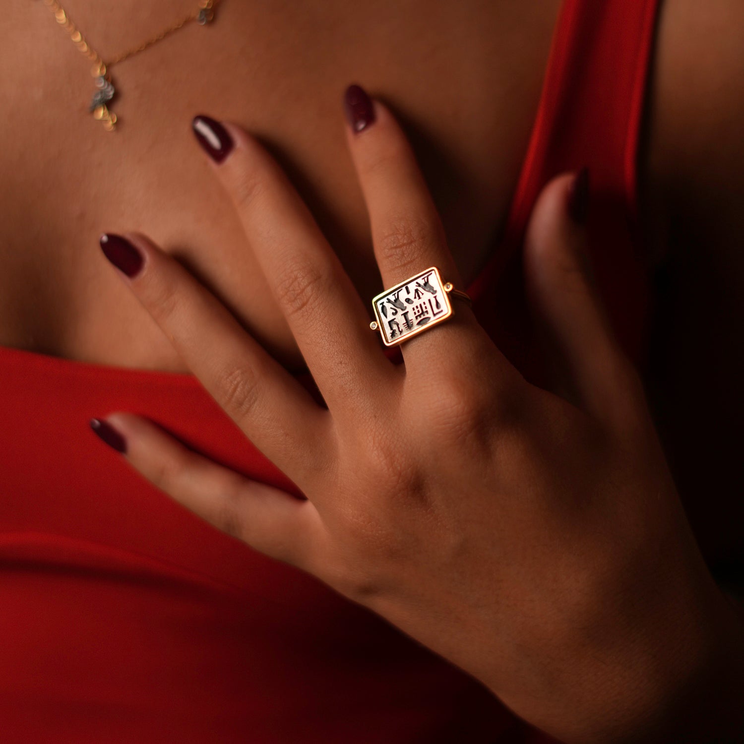 Luxurious adjustable ring with a rectangular sterling silver face and gold-plated frame, showcasing spiritual Egyptian symbols, adjustable from size 5.5 to 9.