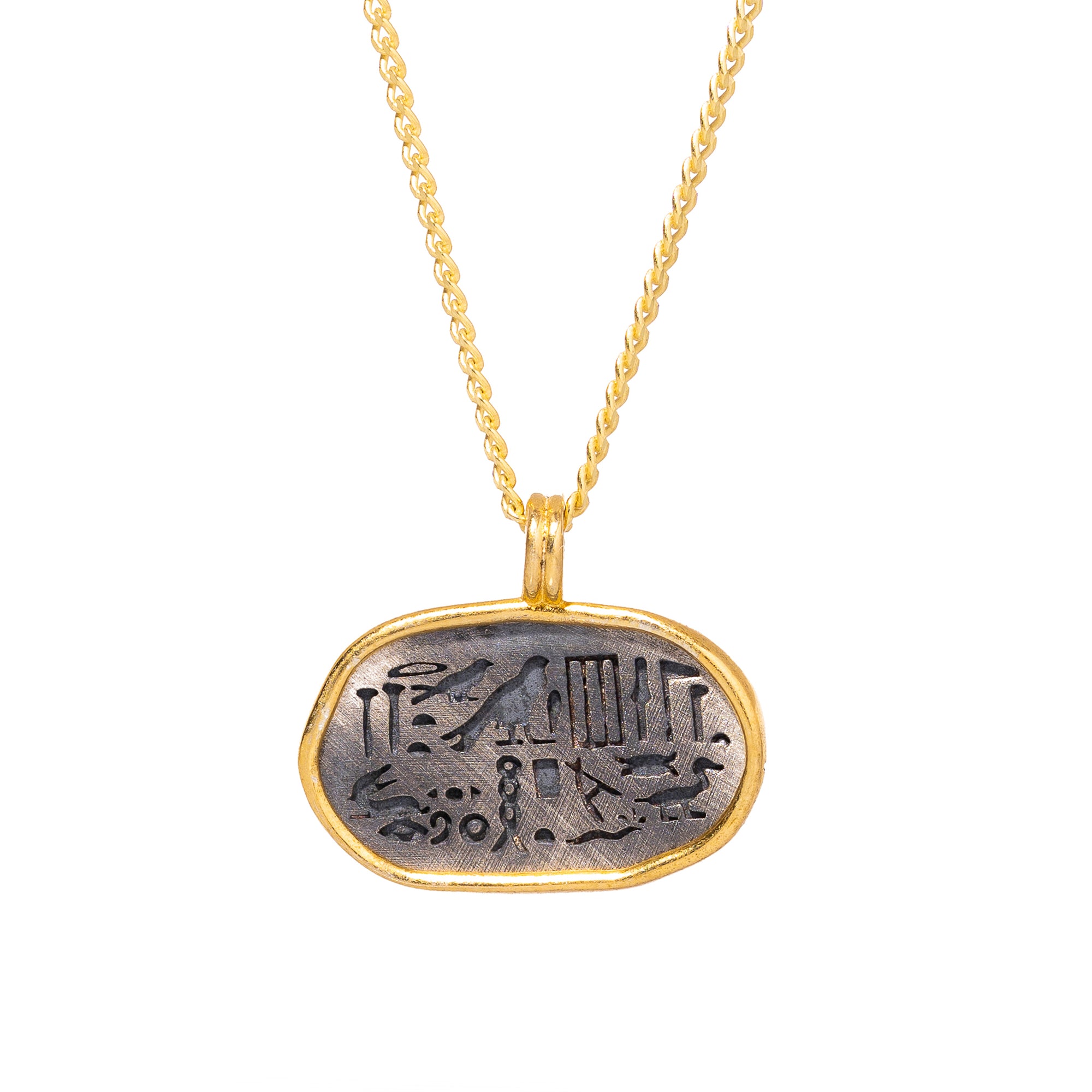 Sterling silver and gold oval pendant necklace with Egyptian symbols, blending spirituality and elegant design.