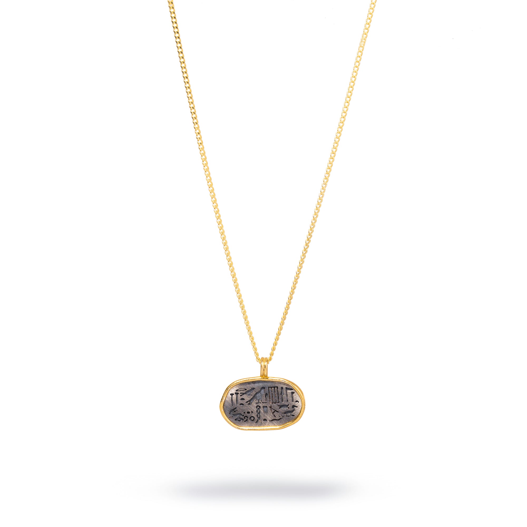 Sterling silver necklace with a gold-framed oval pendant featuring ancient Egyptian symbols for spiritual guidance.