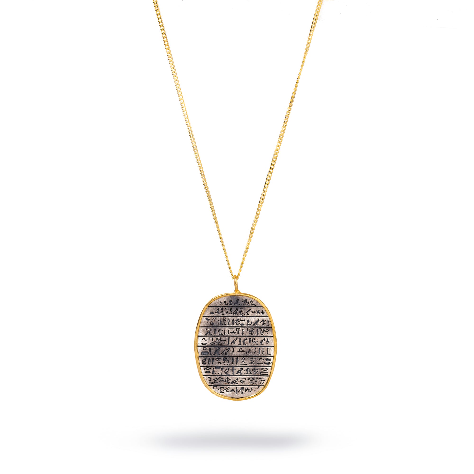 Sterling silver pendant with Egyptian symbols framed in 18k gold, hanging on a gold-plated chain.