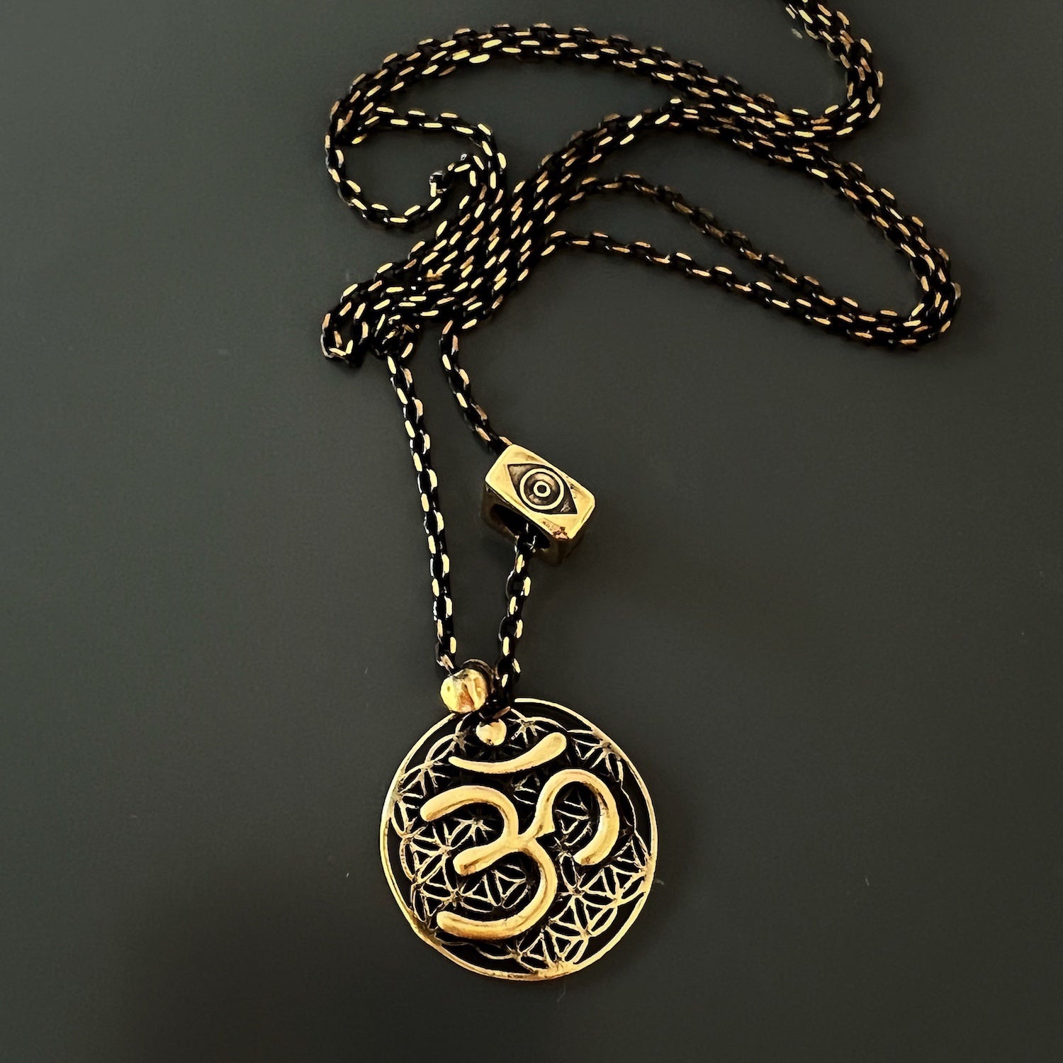 The Spiritual Symbols Om Necklace, a perfect accessory for yoga and meditation enthusiasts, symbolizing unity, protection, and spiritual connection.