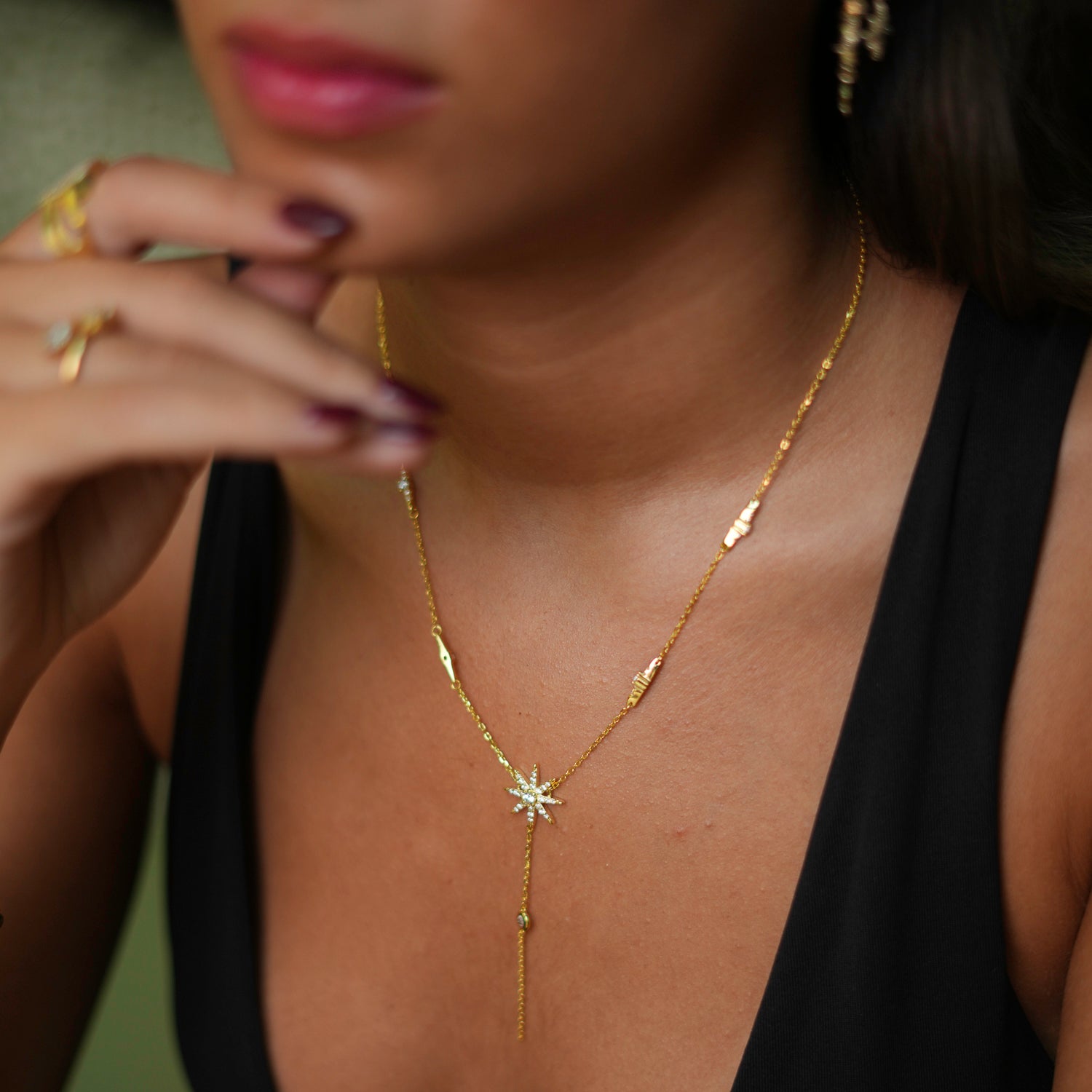 Elegant gold-plated sterling silver necklace featuring a star pendant with diamond details and cascading diamonds along the chain.