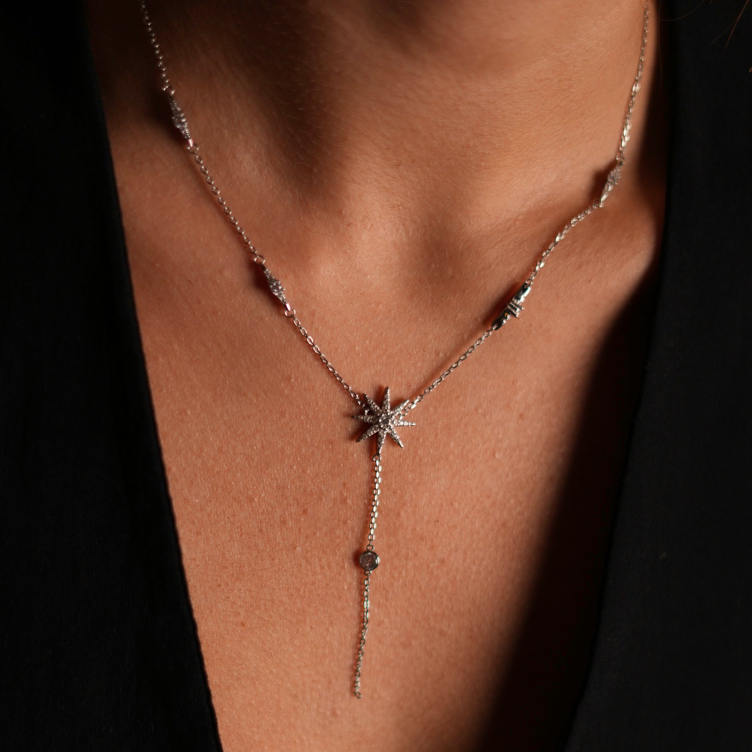 Unique sterling silver necklace featuring a star pendant with CZ diamonds and diamond accents along the chain, handmade in the USA.