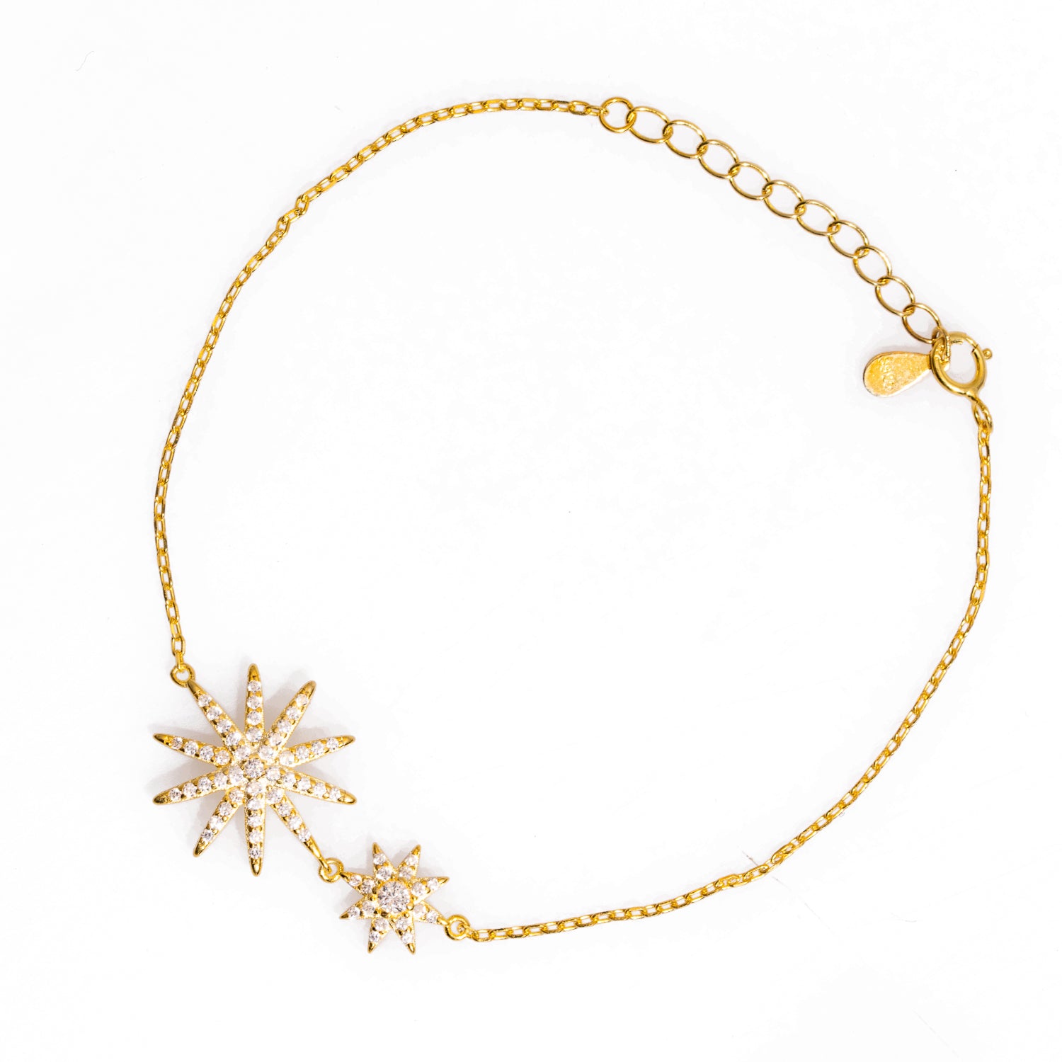 Sophisticated gold-plated sterling silver bracelet with star-shaped charms and CZ diamonds, designed to illuminate your style.